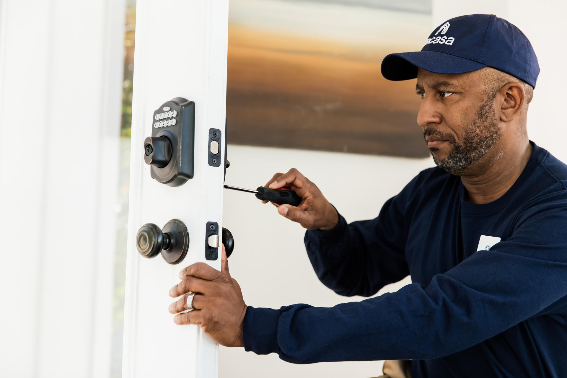 Man implementing a Smart lock on a home.