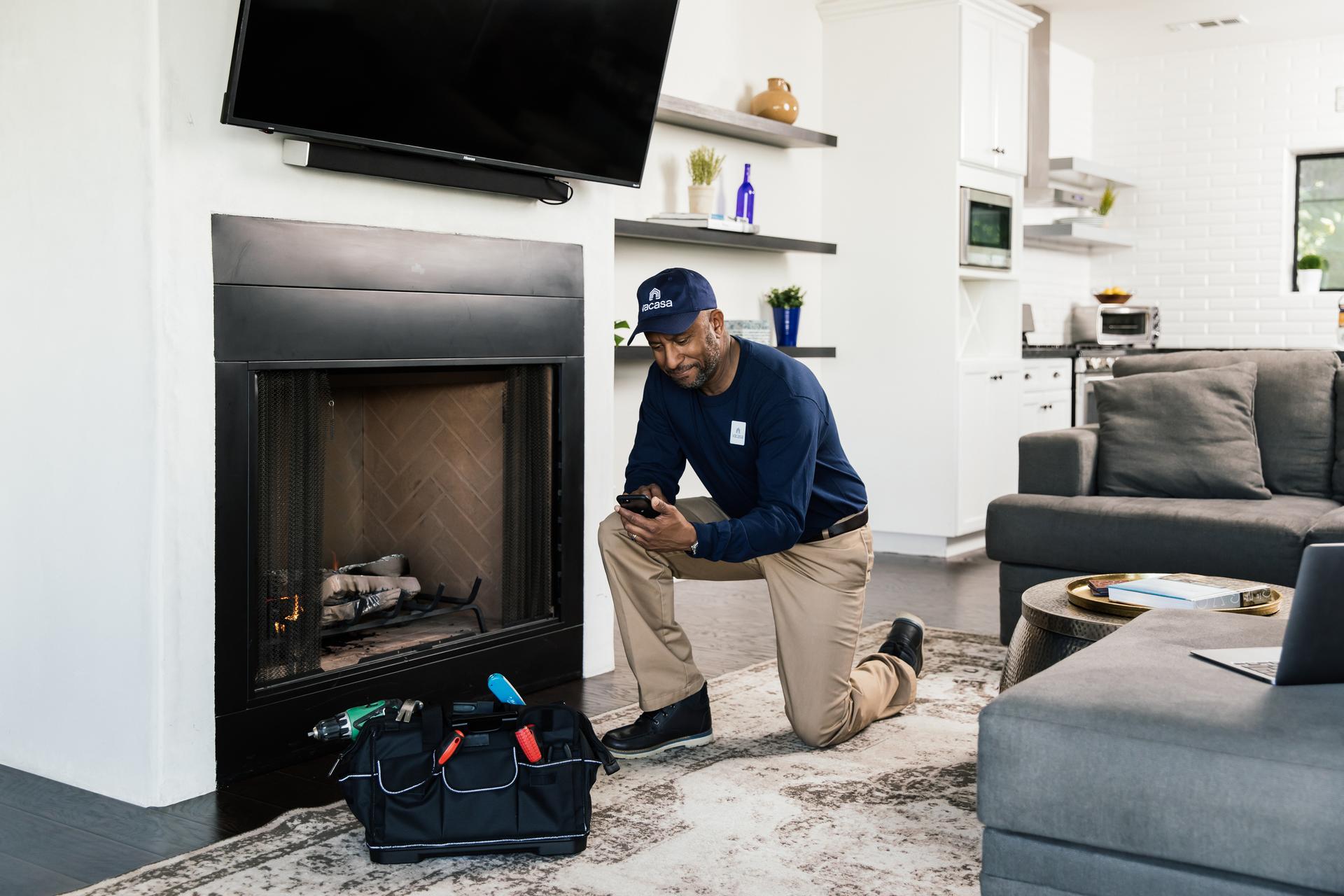 Man using a phone at a vacation rental for repairs.