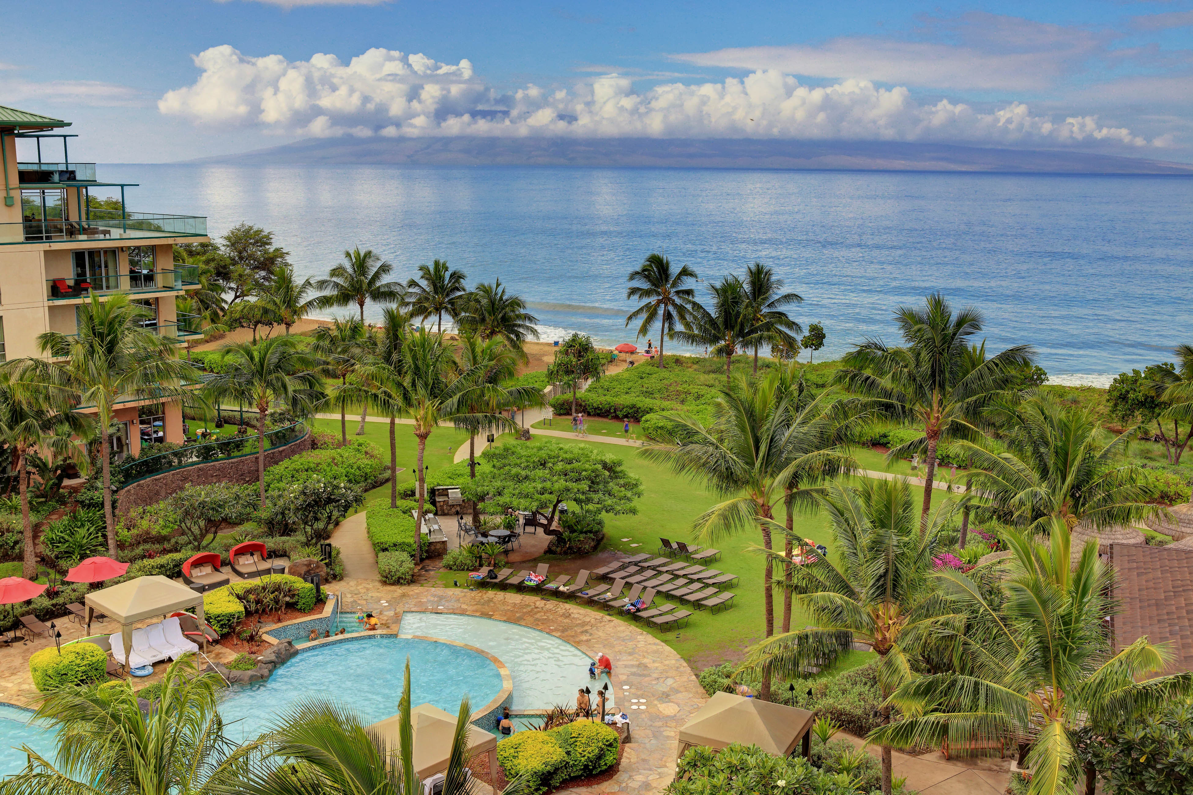 Resort grounds with resort pool and manicured lawns at Honua Kai Resort