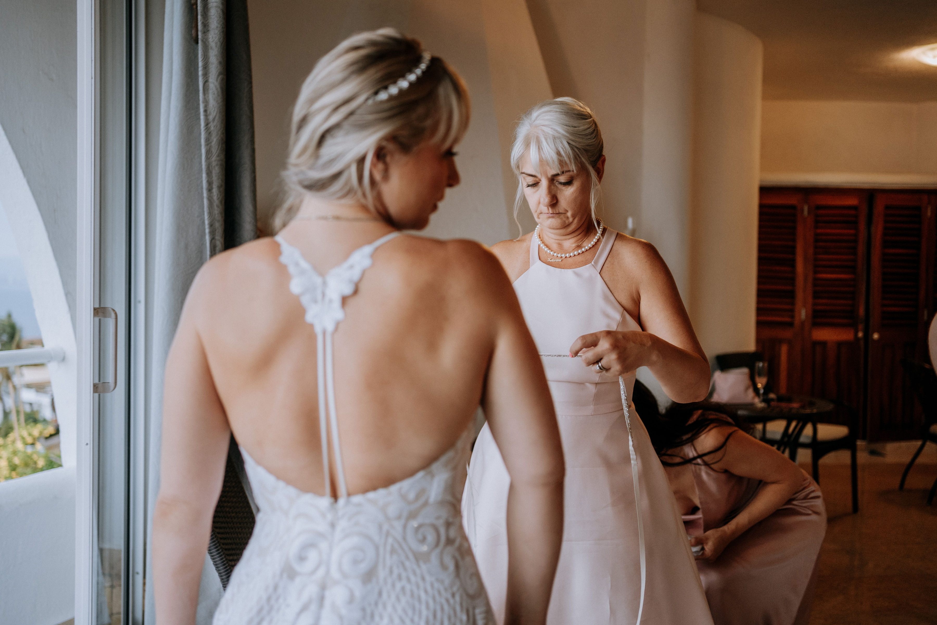 Mom and daughter sizing wedding dress.
