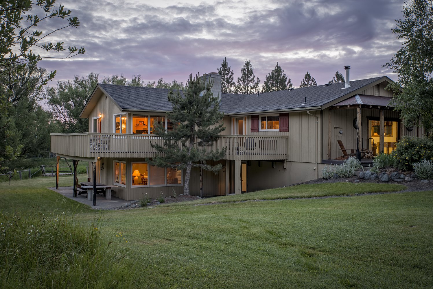 Large house with the lights on during the evening