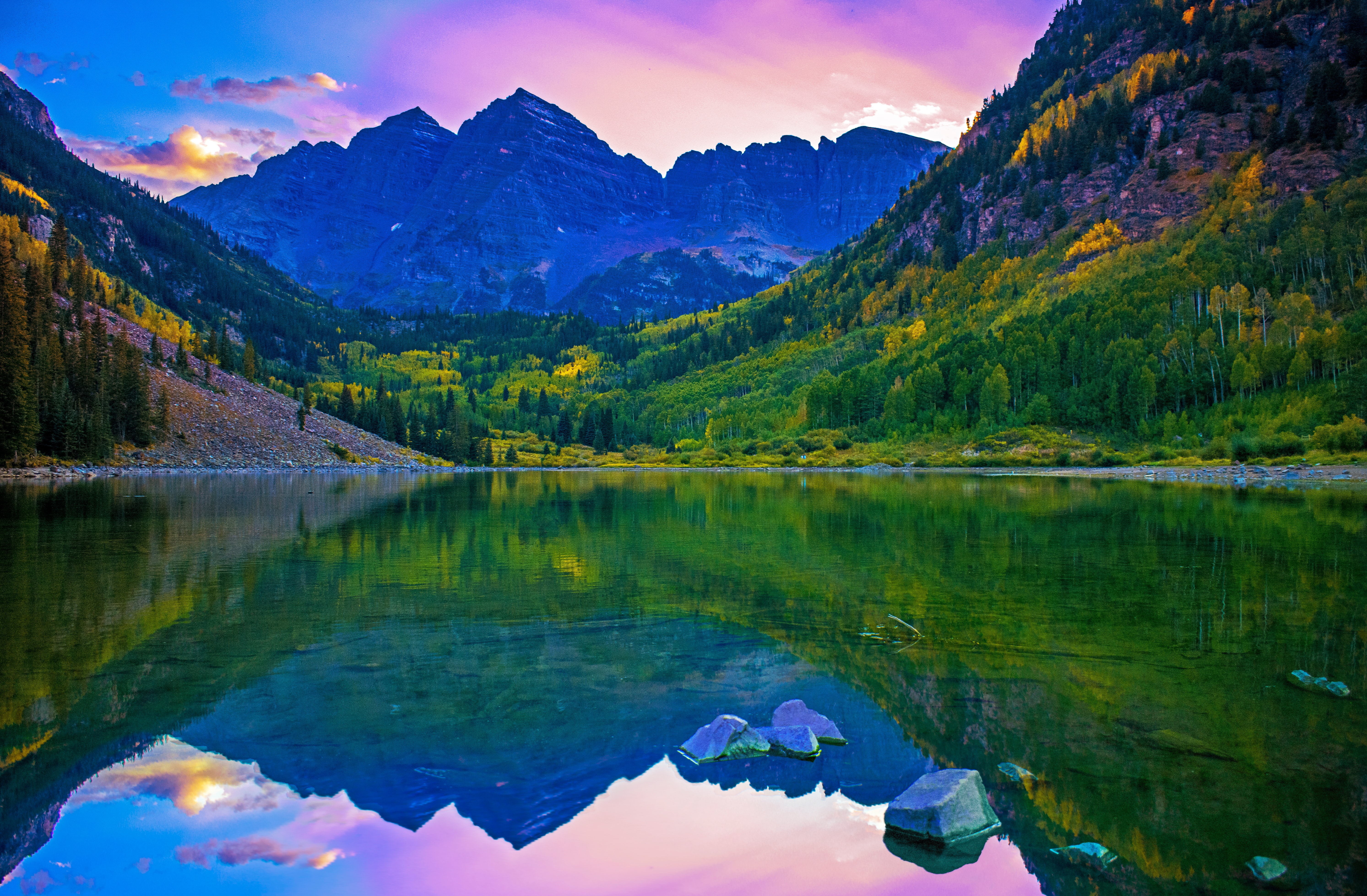 Crystal clear water at Maroon Lake facing a large mountain peak during a sunset