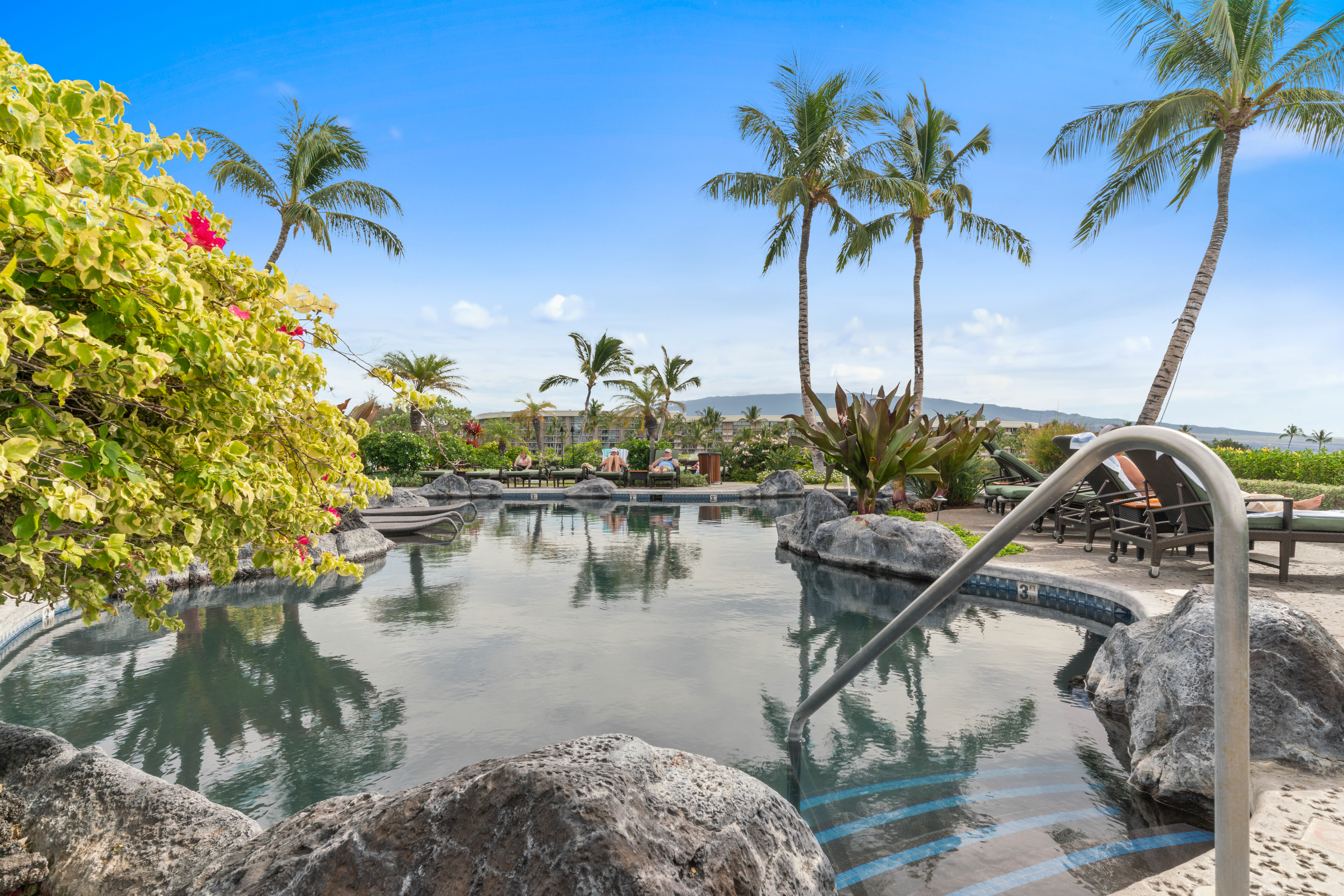 Mauna Lani pool with rock features and palm trees