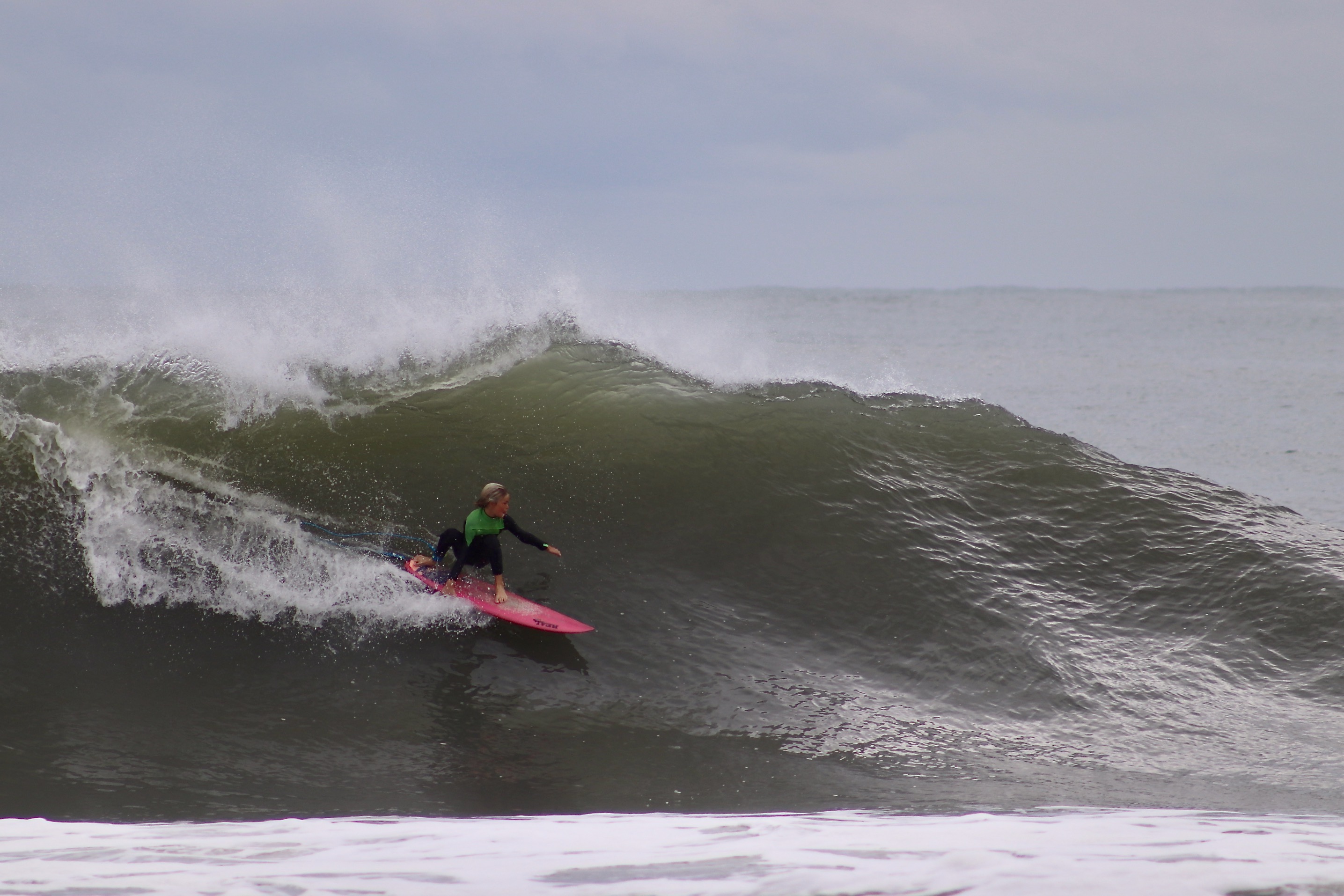 Surfer in the Outer Banks catching a wave
