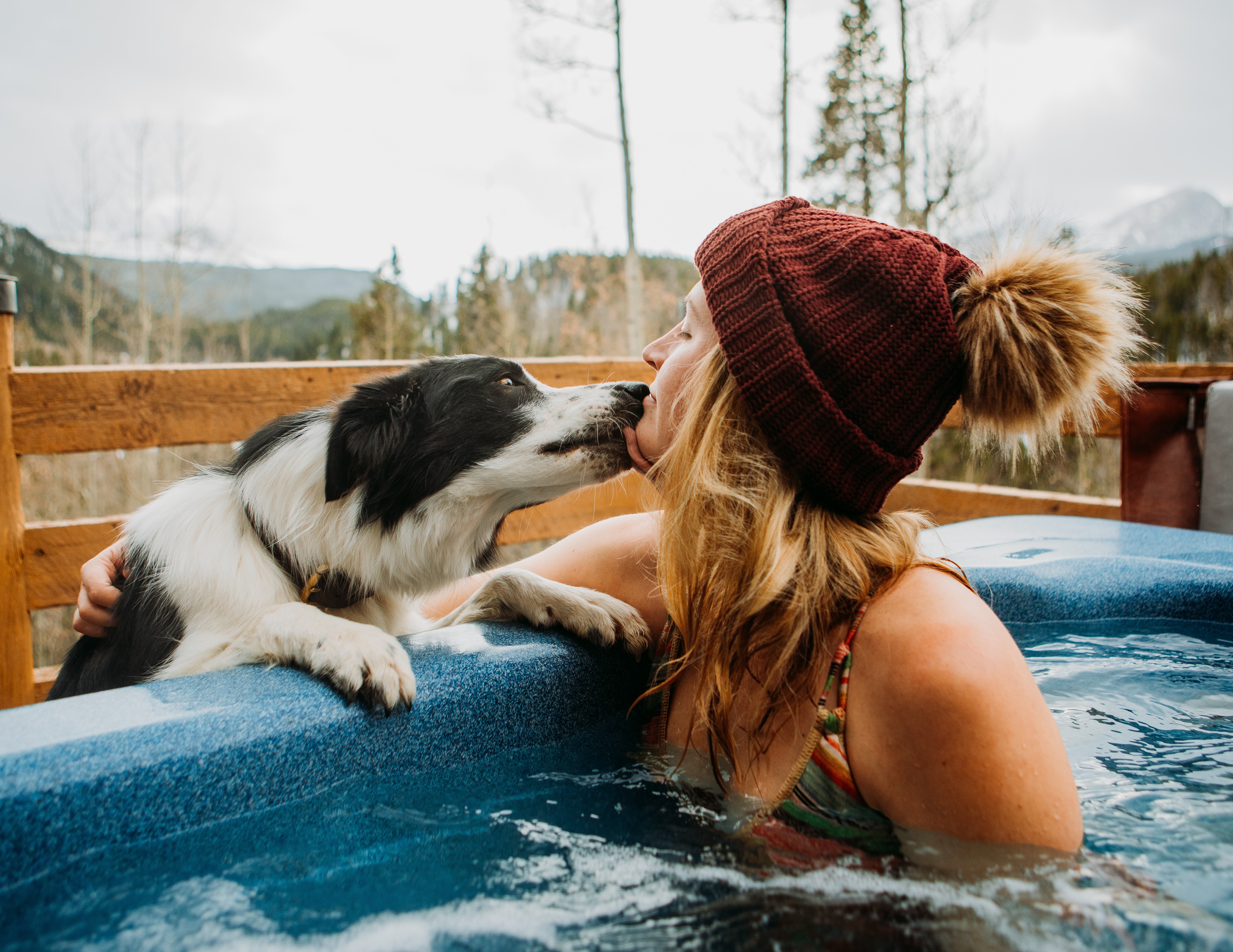 Ashley with her dog Lamothe in a hot tub.