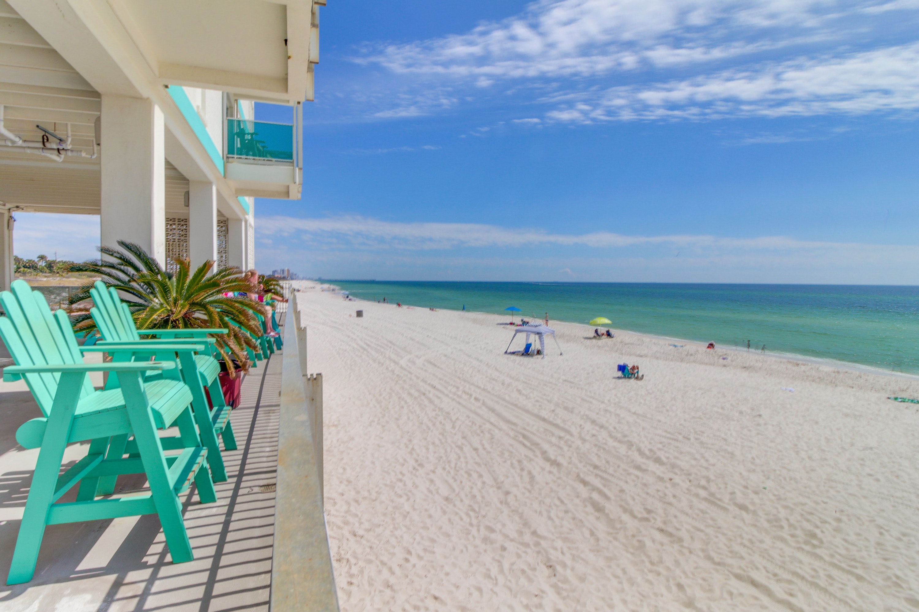 Turquoise chairs overlooking turquoise waters of Panama City Beach
