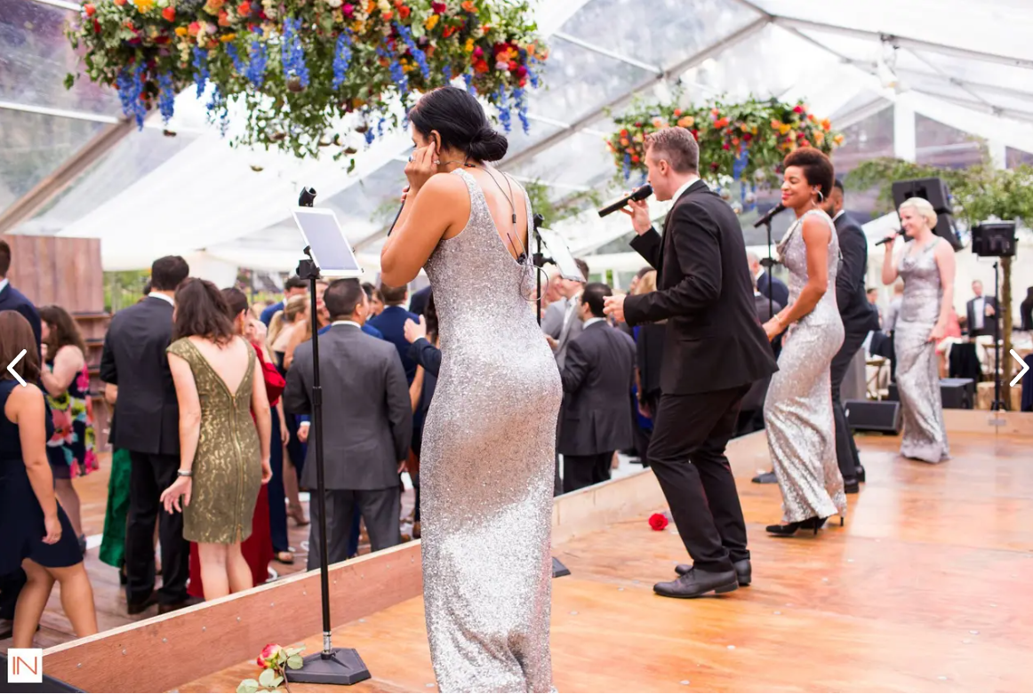 Folks singing on stage at a wedding at Lion Square Lodge.