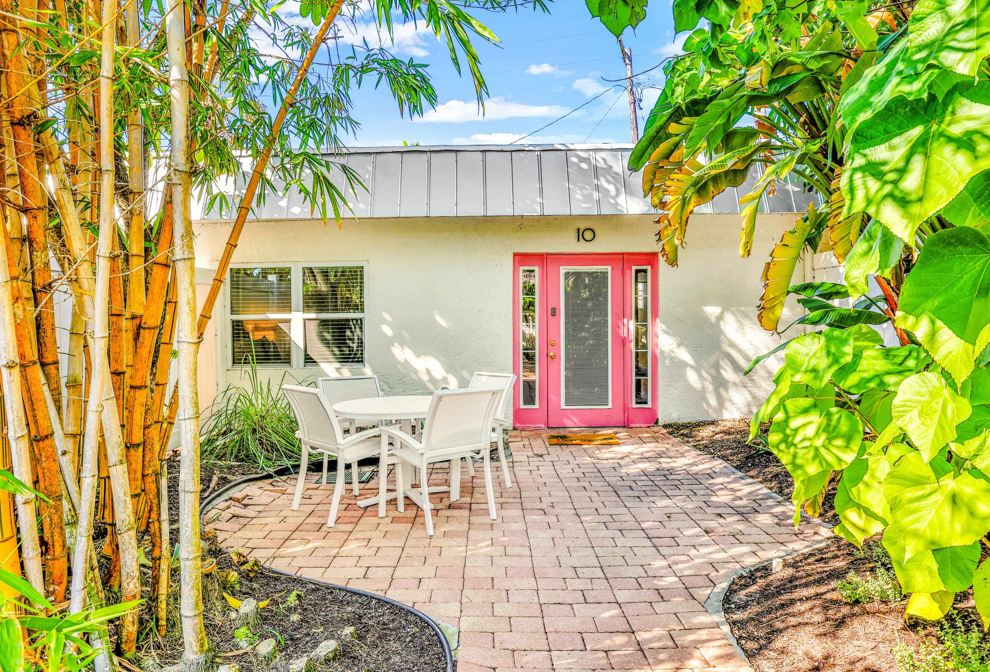 Pathway to room at a resort with bamboo trees during the day.
