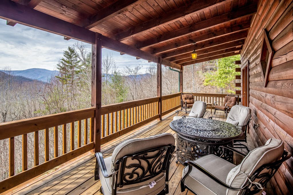 Wooden outdoor deck with patio furniture and mountain views