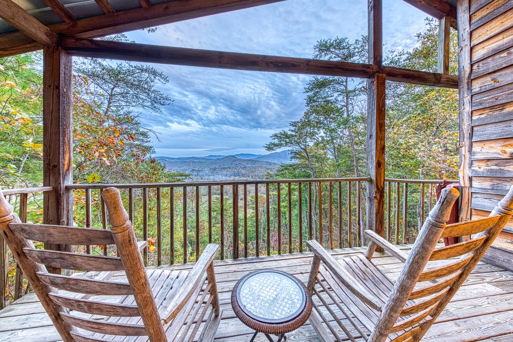 Rocking chairs facing the mountains on an outdoor deck of a vacation home in Townsend, TN