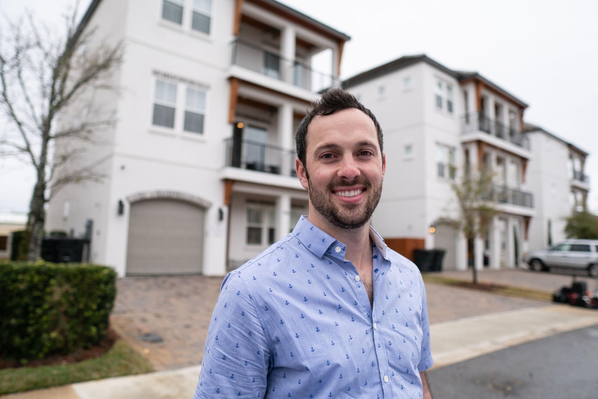 homeowner Max stands in the street in front of his vacation home