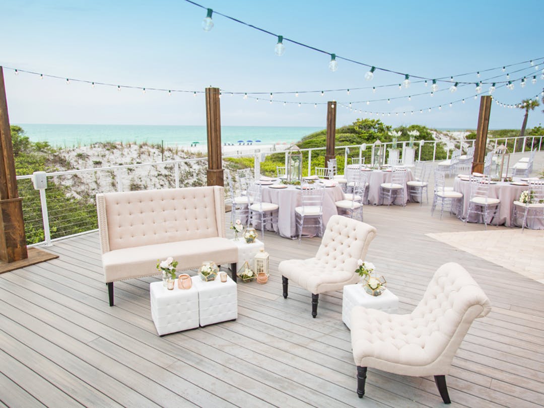 large deck of oceanfront resort set up for a wedding reception