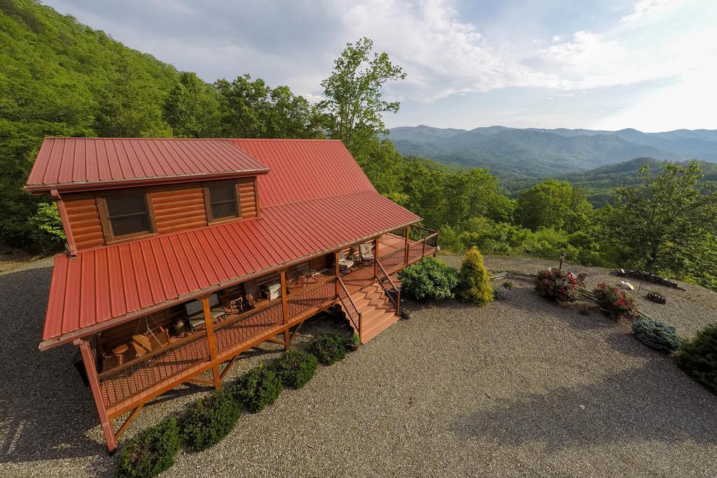 Red cabin with a wrap around deck in the mountains of Wittier, NC