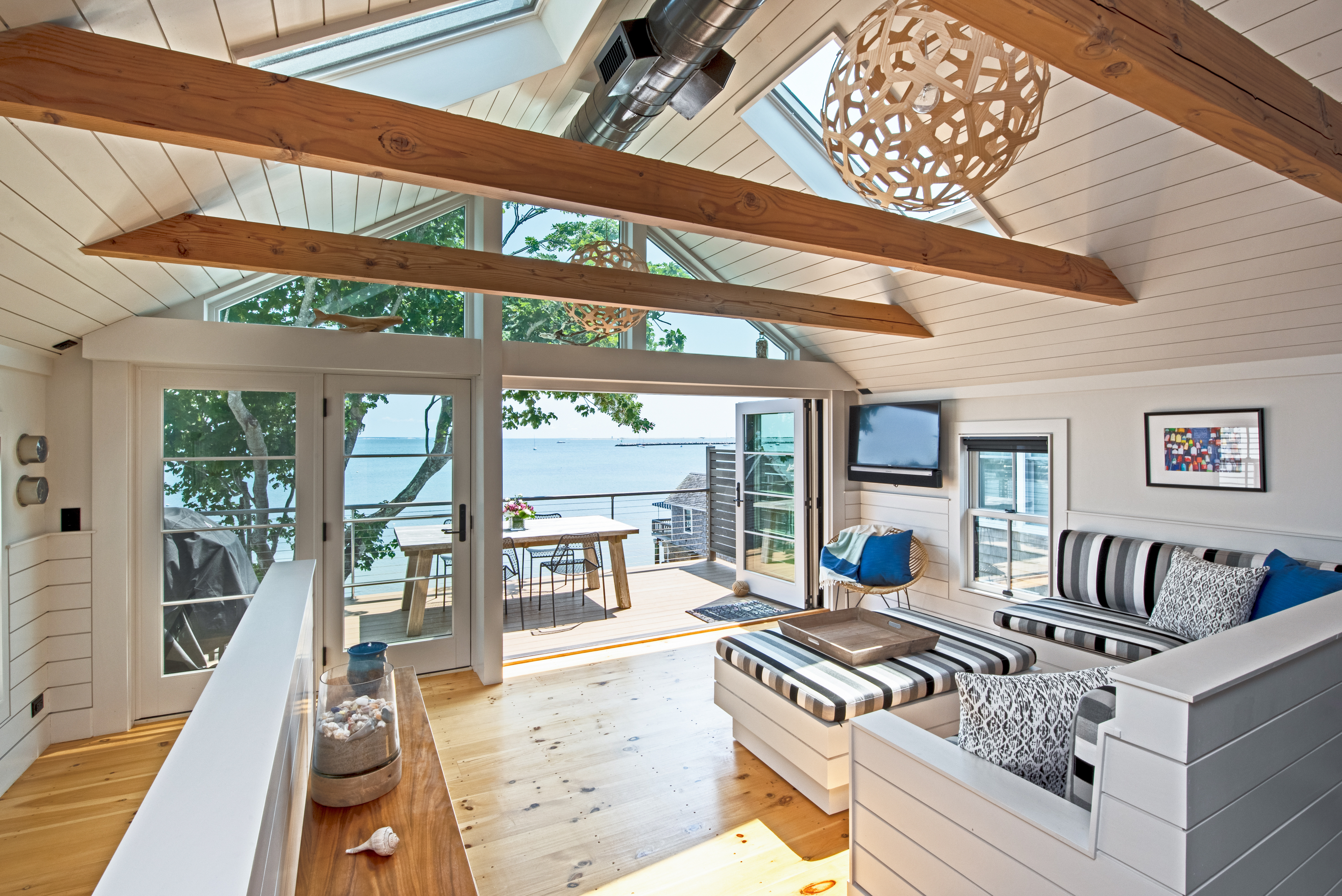 The exterior of a vacation rental with charming design overlooking the ocean.