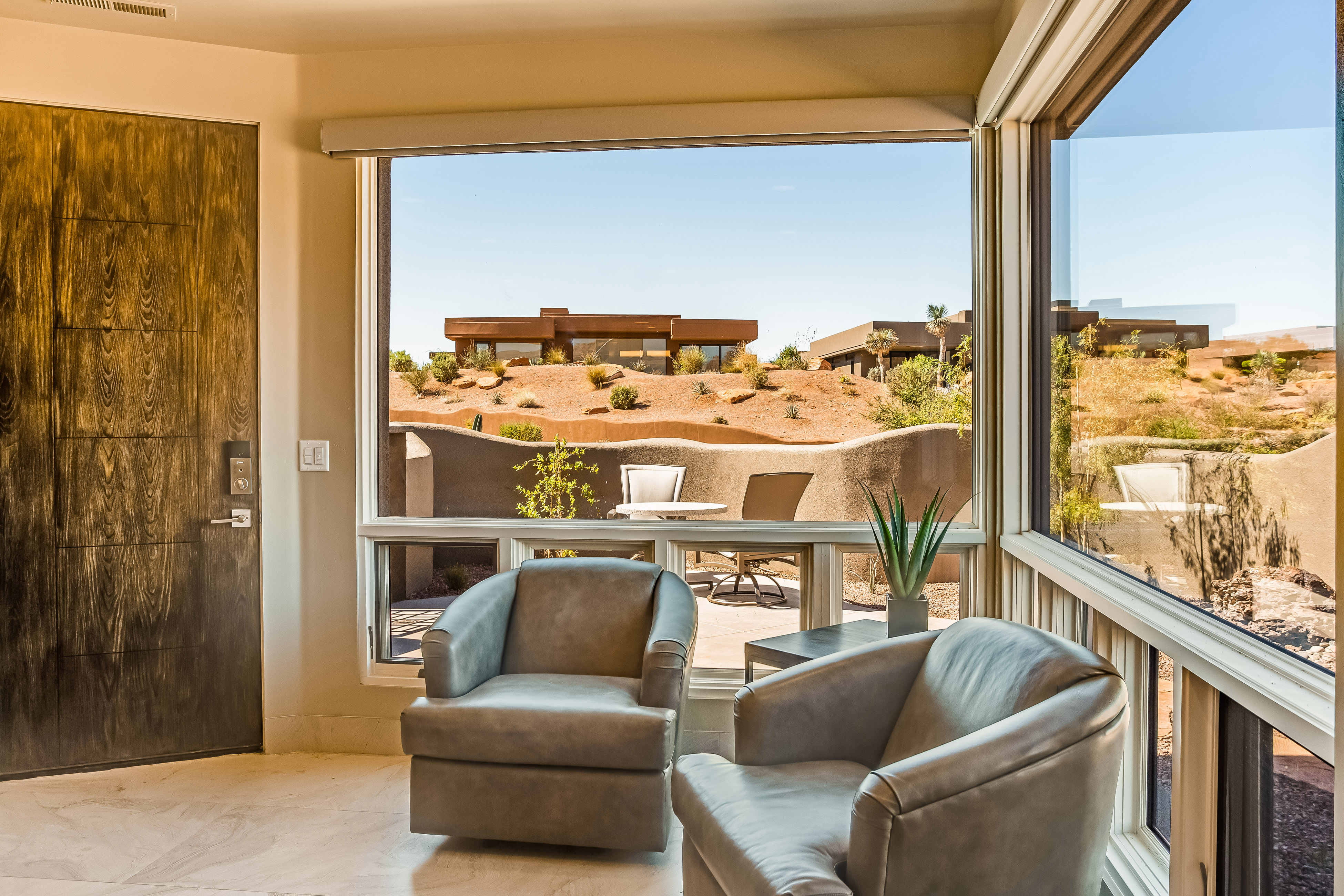 Two chairs at a condo rental in St. George, Utah near Zion with two other homes in the background.