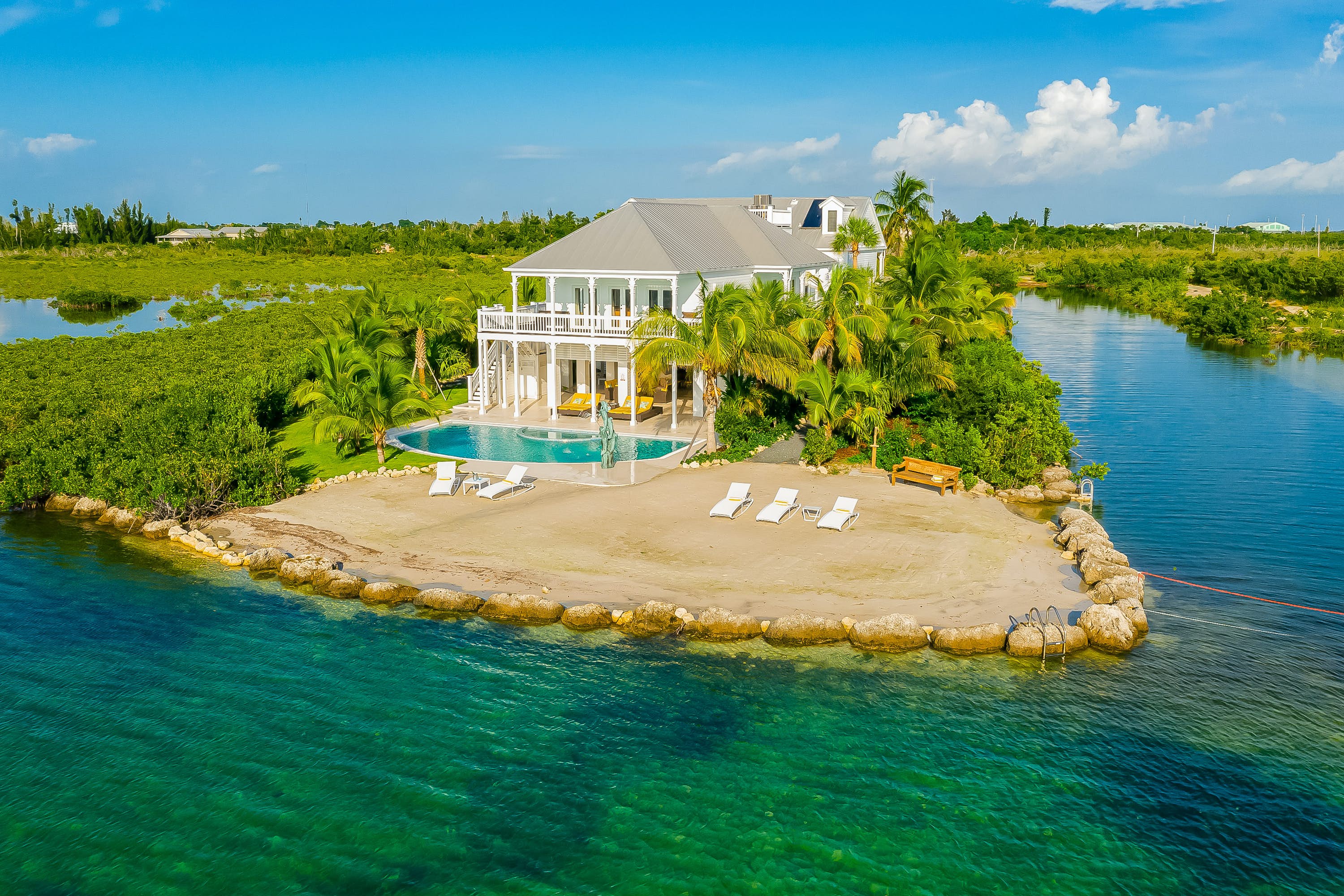 Large vacation home next to a canal with an outdoor pool.