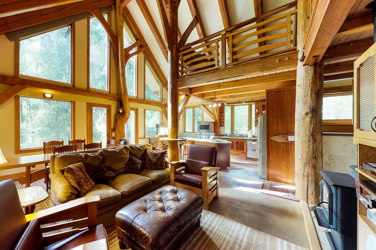 a unique living room with large tree trunks throughout the interior
