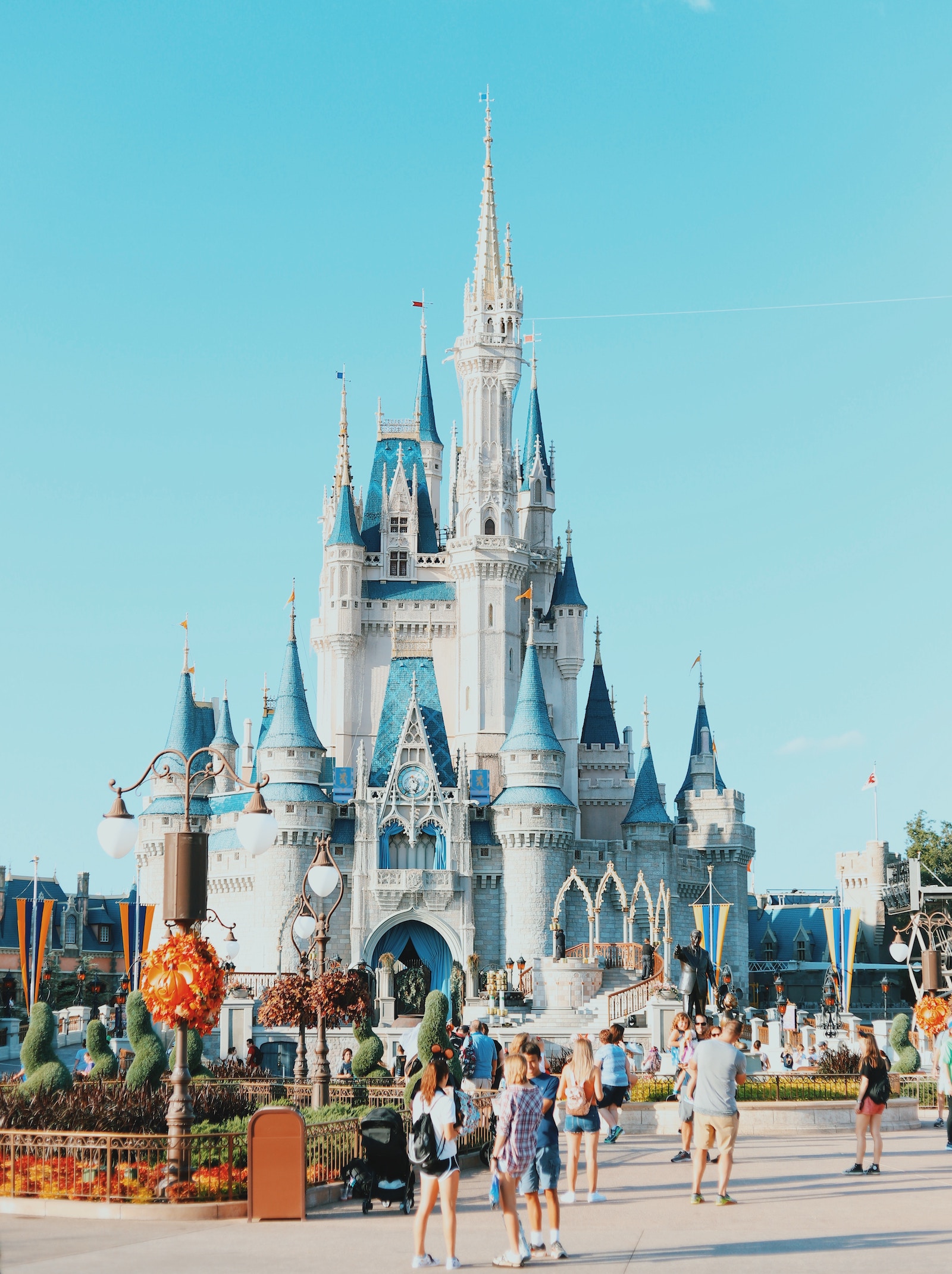 Image of Disney World castle with tourists and folks visiting.