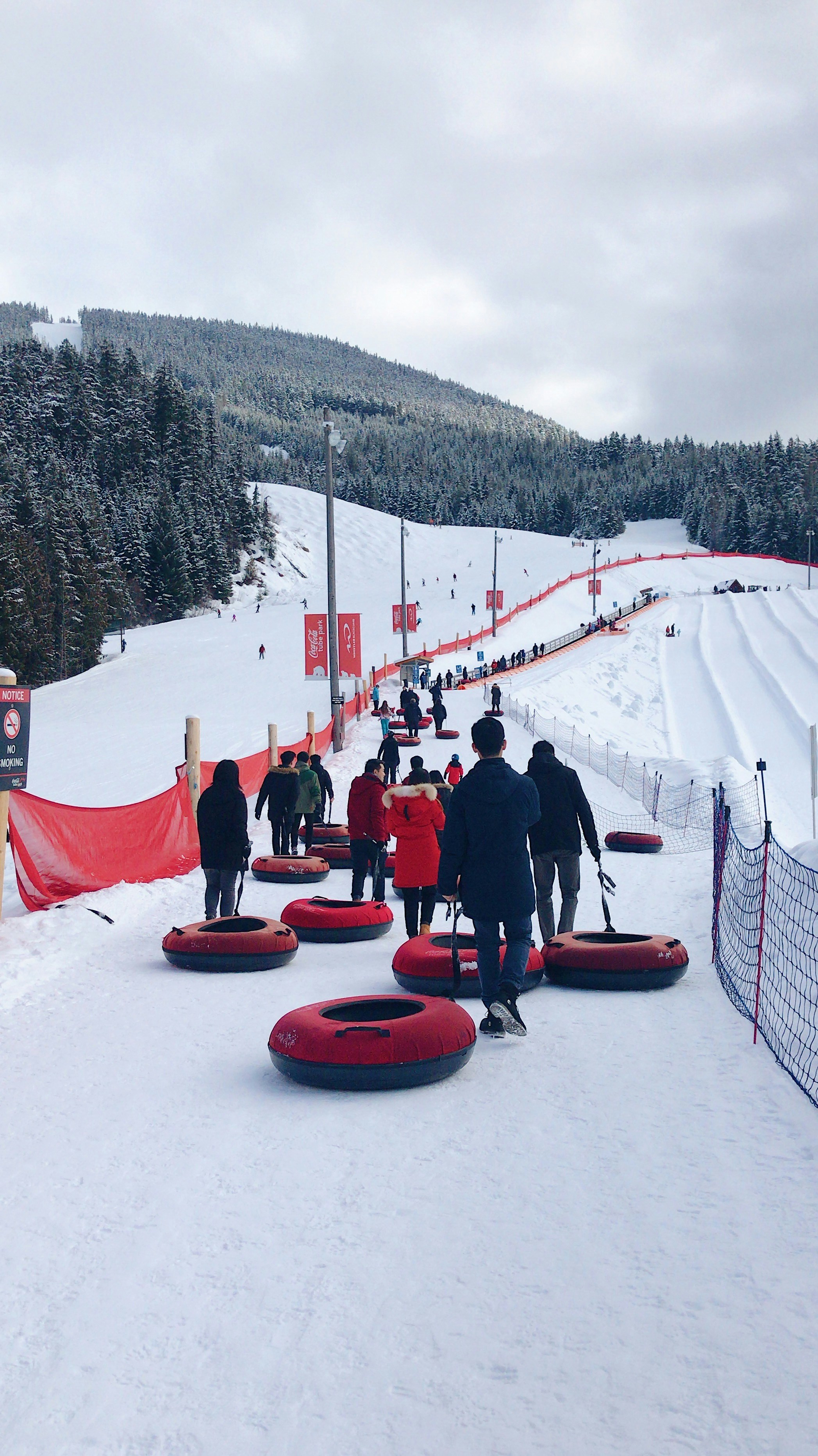 people pull their tubes for snowtubing in whistler