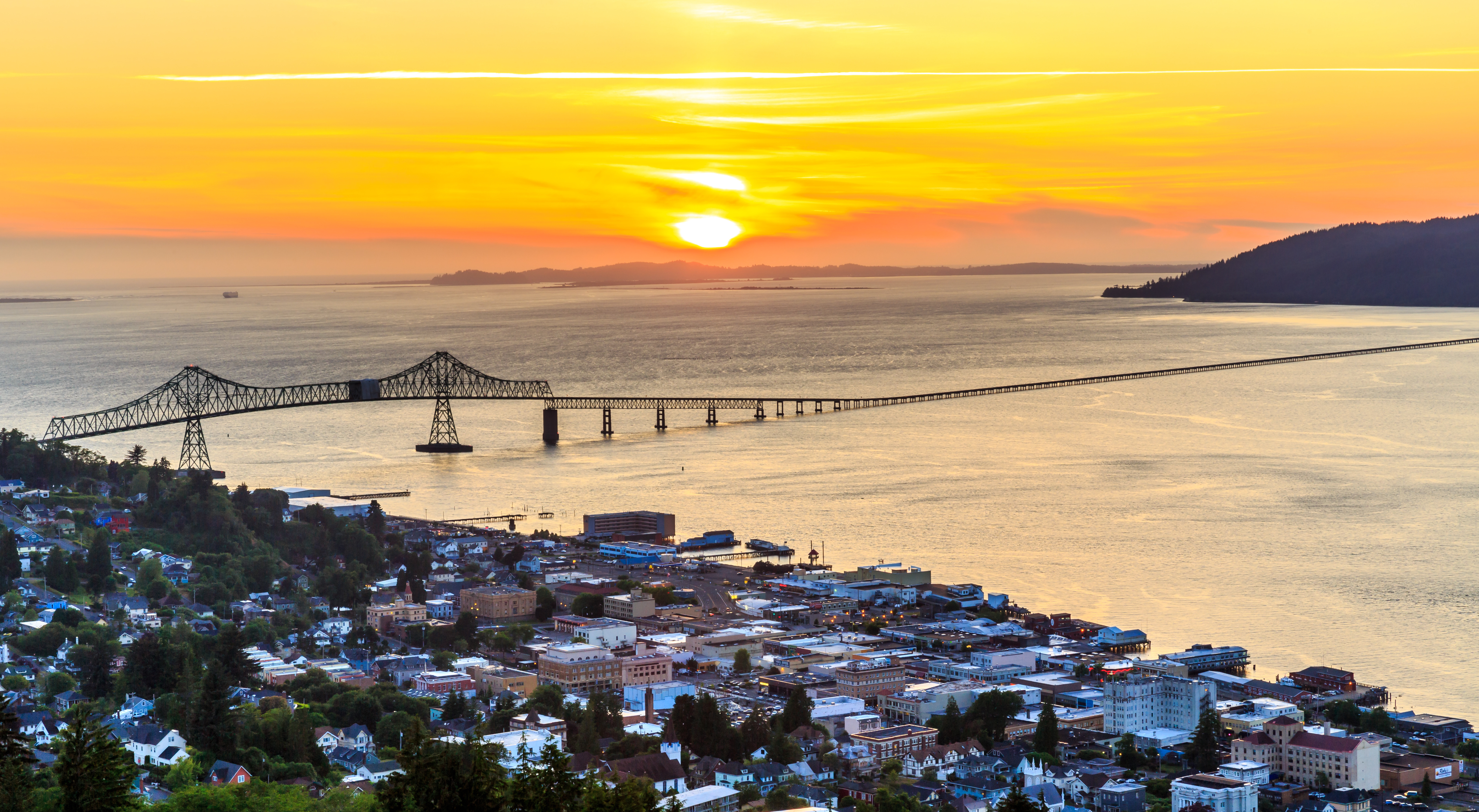 Aerial view of Astoria, OR and the town with a large long bridge
