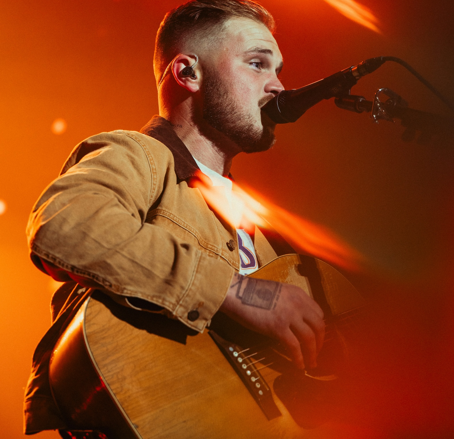 Country musician playing guitar for CMA Festival.