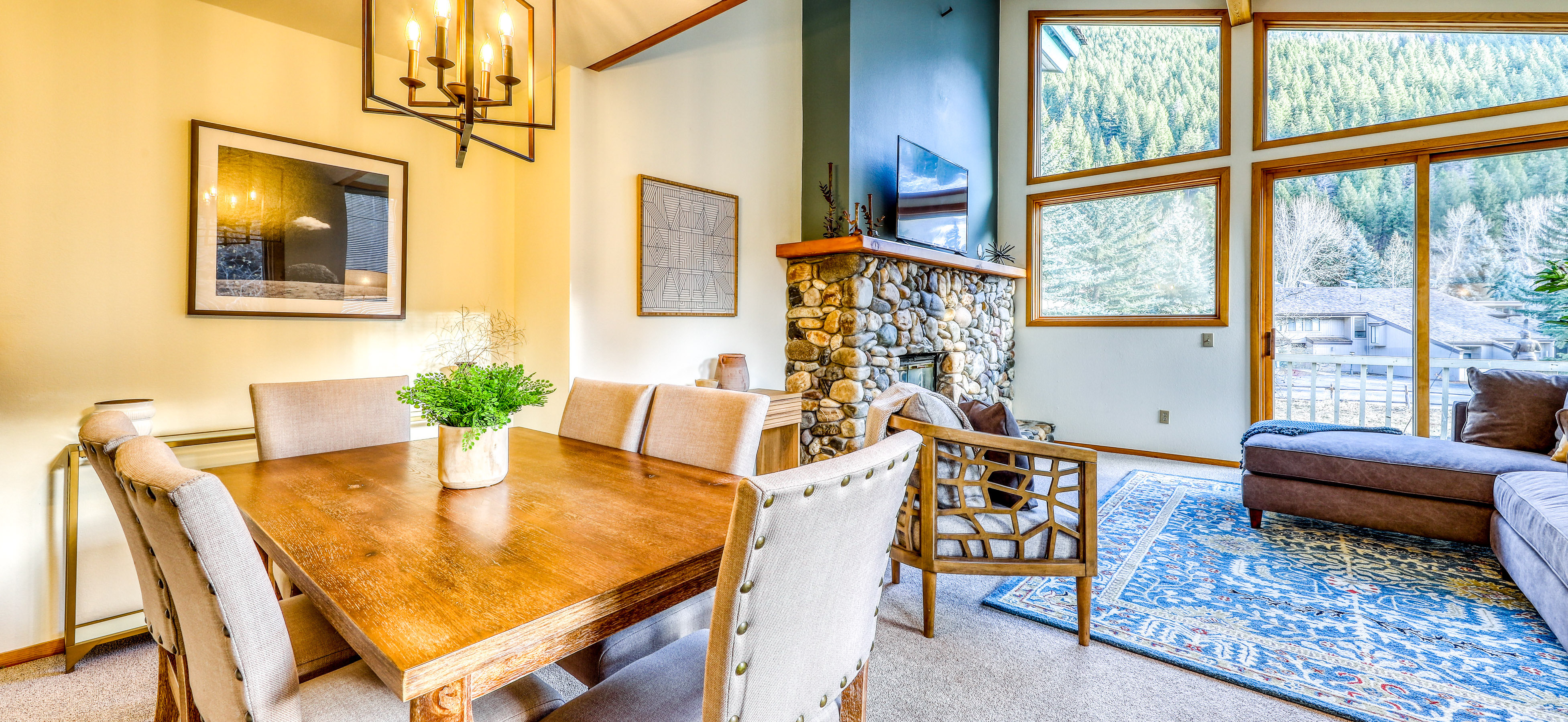 interior of Ketchum, ID cabin home with stone fireplace, an indoor plant and area rug