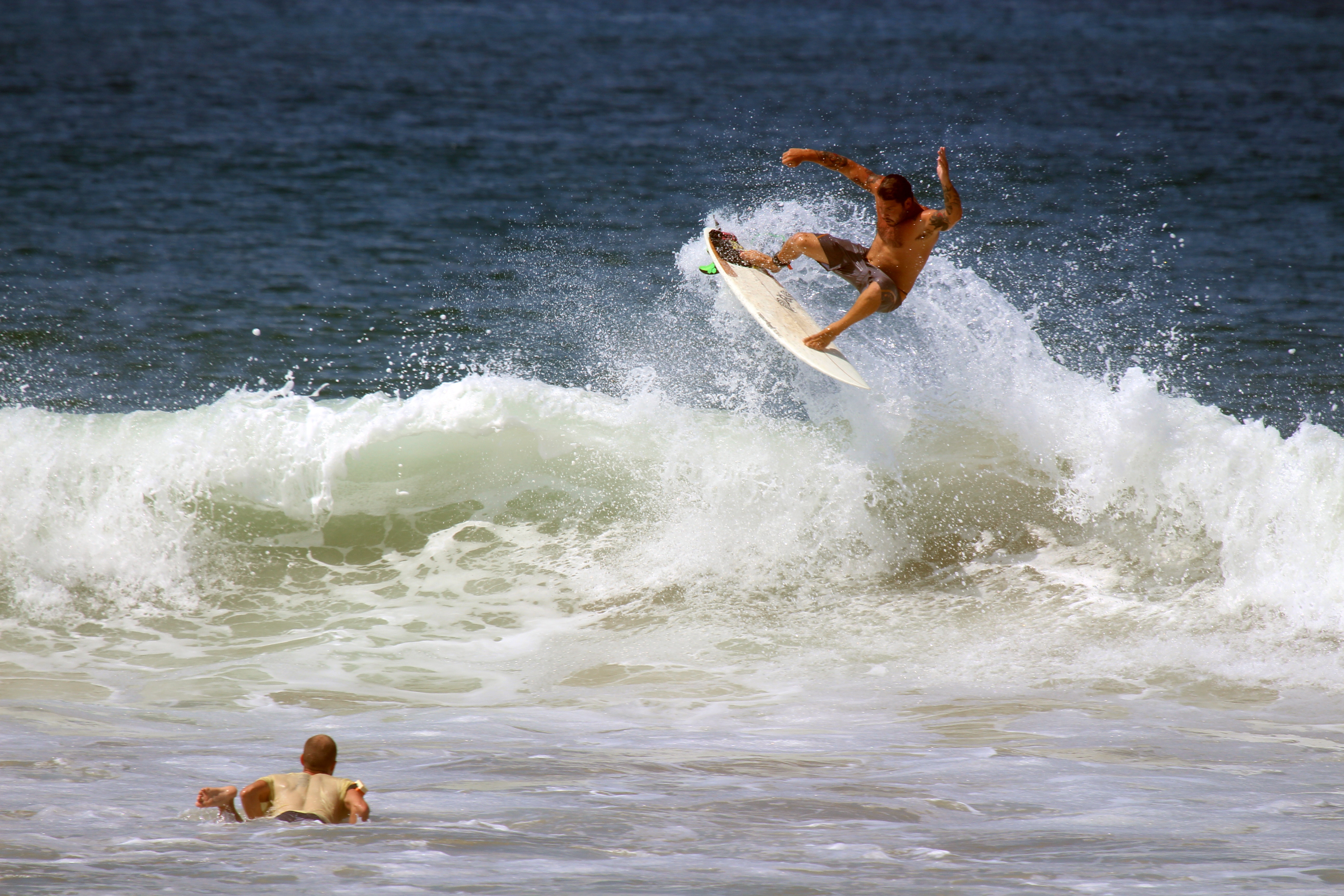 a surfer doing a jump through a wave