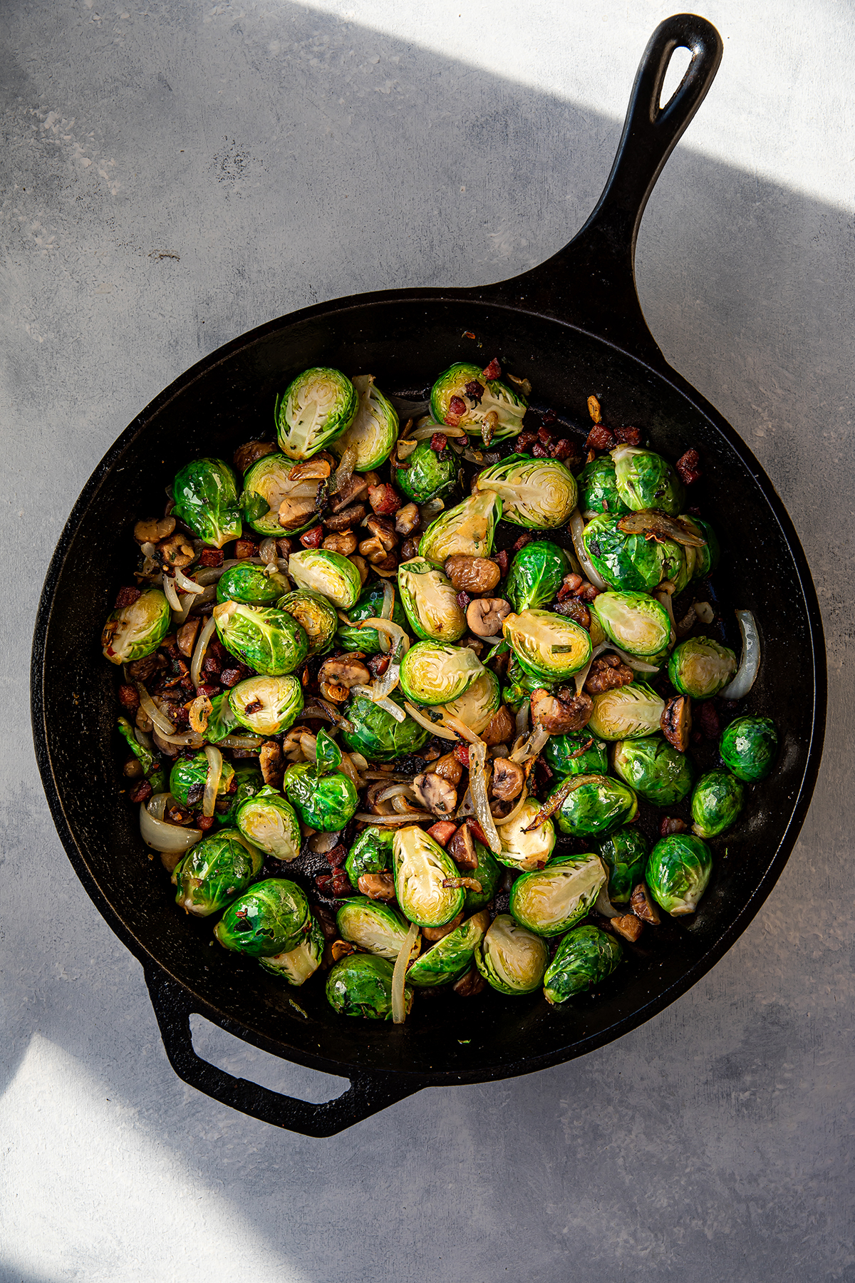 cast iron pan filled with Brussels Sprouts with Chestnuts, Pancetta & Sage