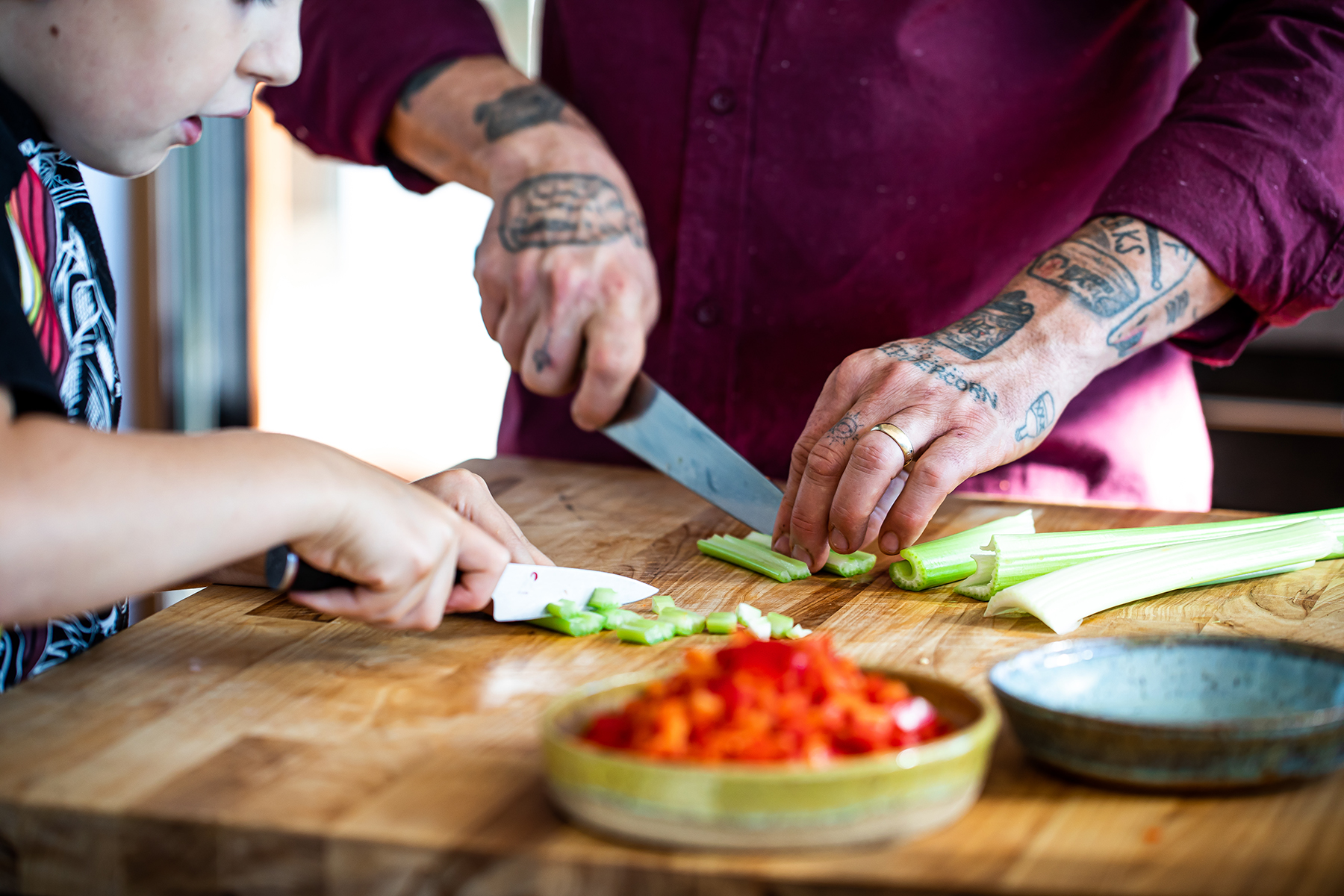chef gabriel chopping vegetables with his son