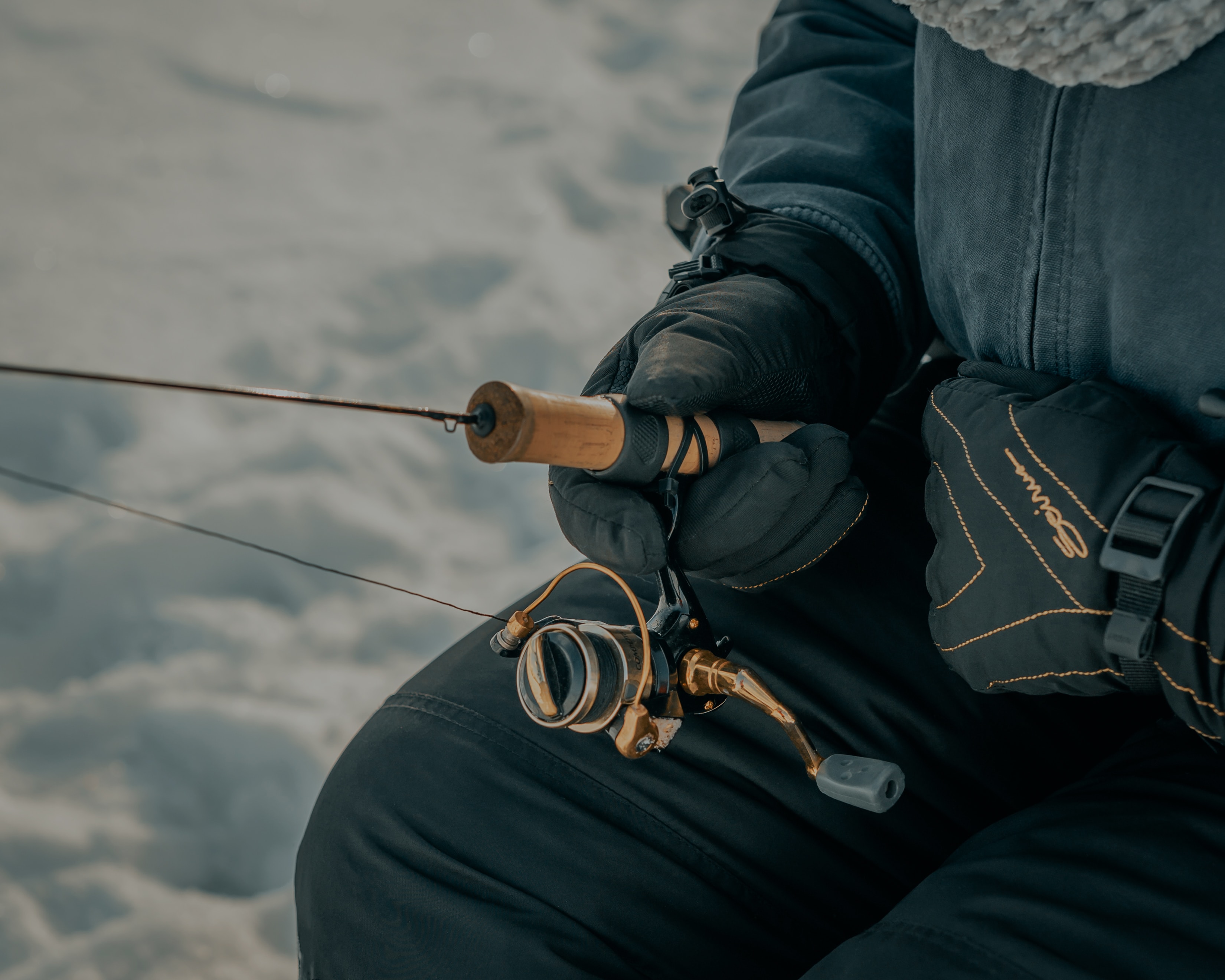 Man ice fishing.