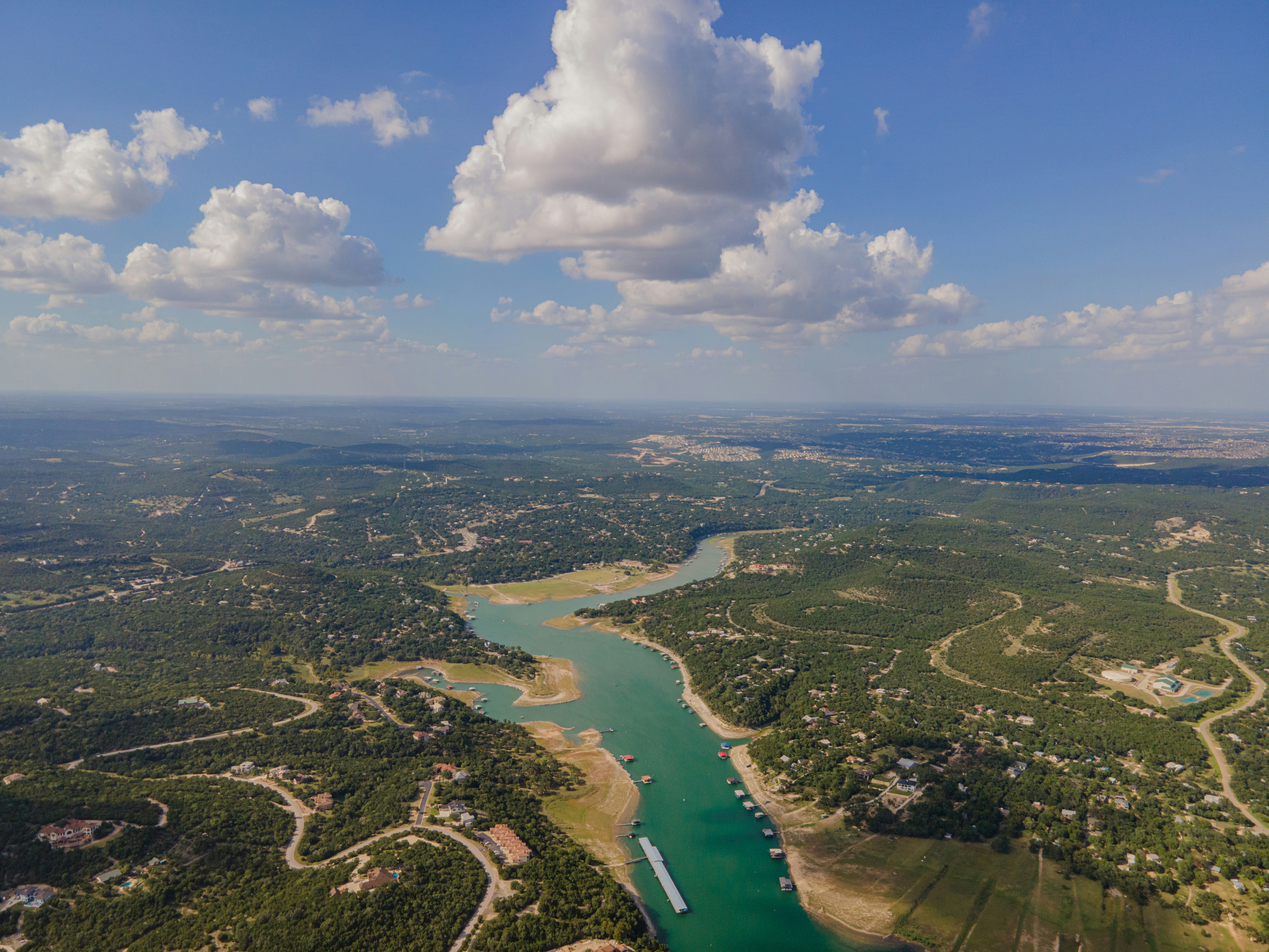 aerial view of lake travis winding its way through texas hill country on a summer day