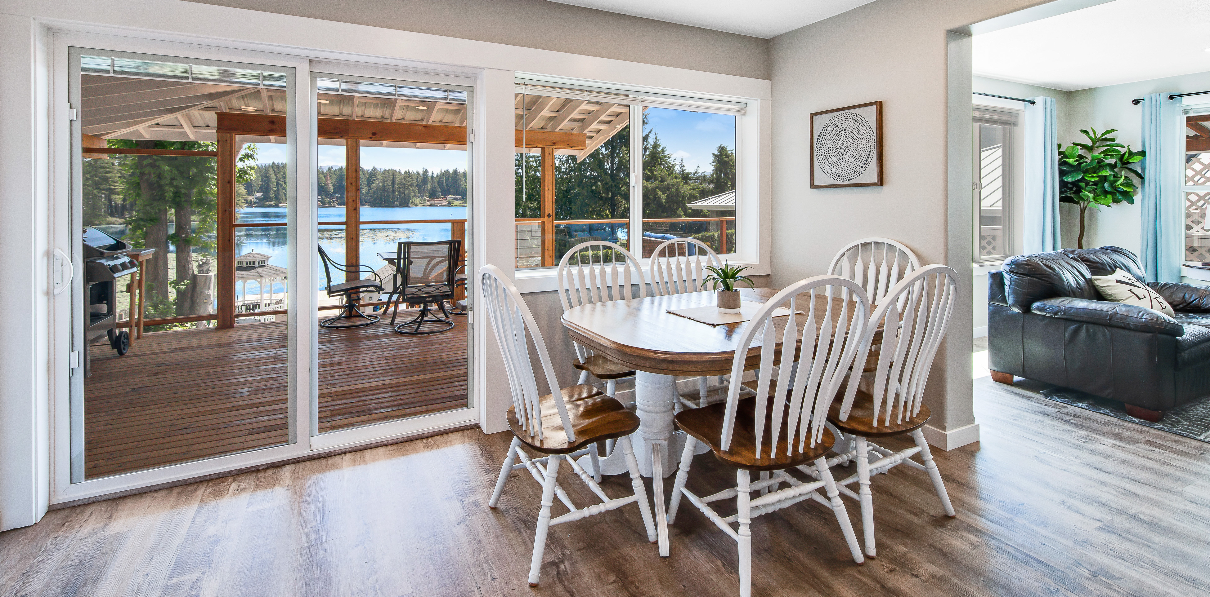 kitchen table in front of sliding glass door to deck of lakefront vacation home