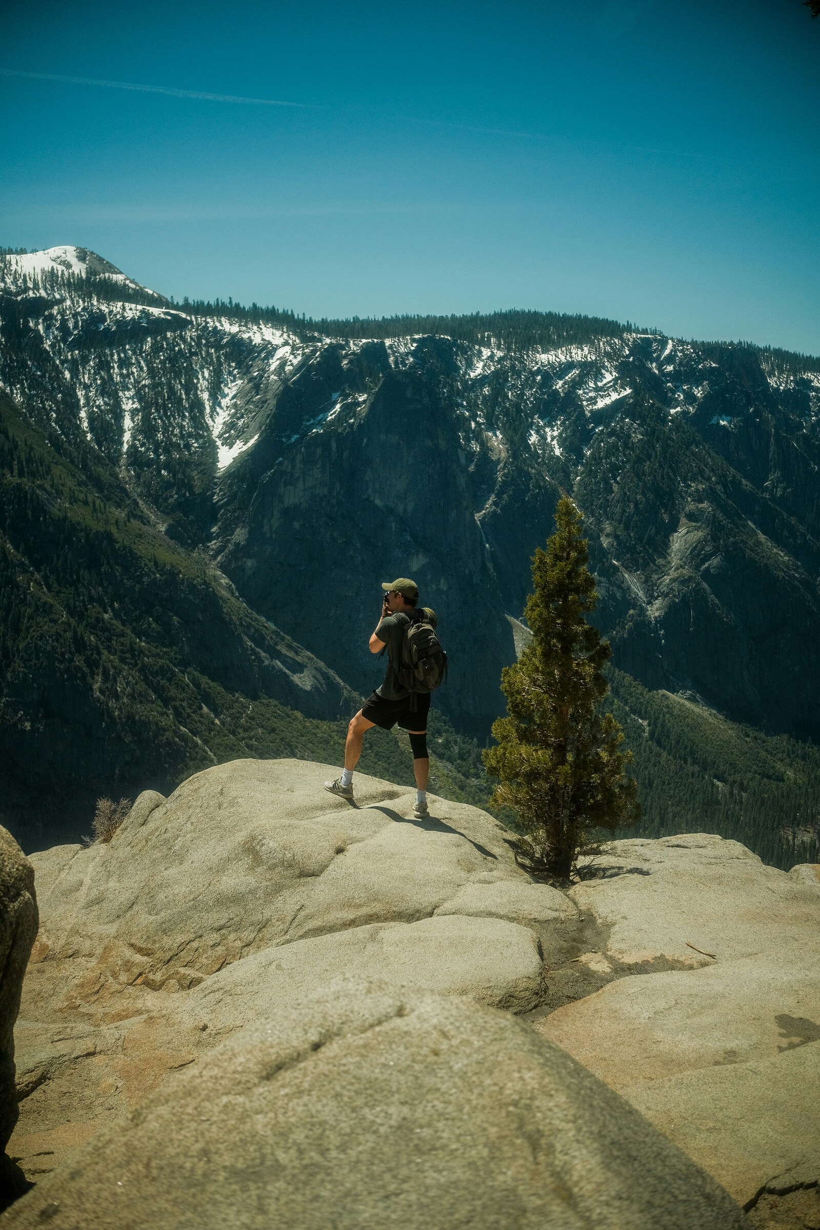 hiker taking a picture of yosemite national park