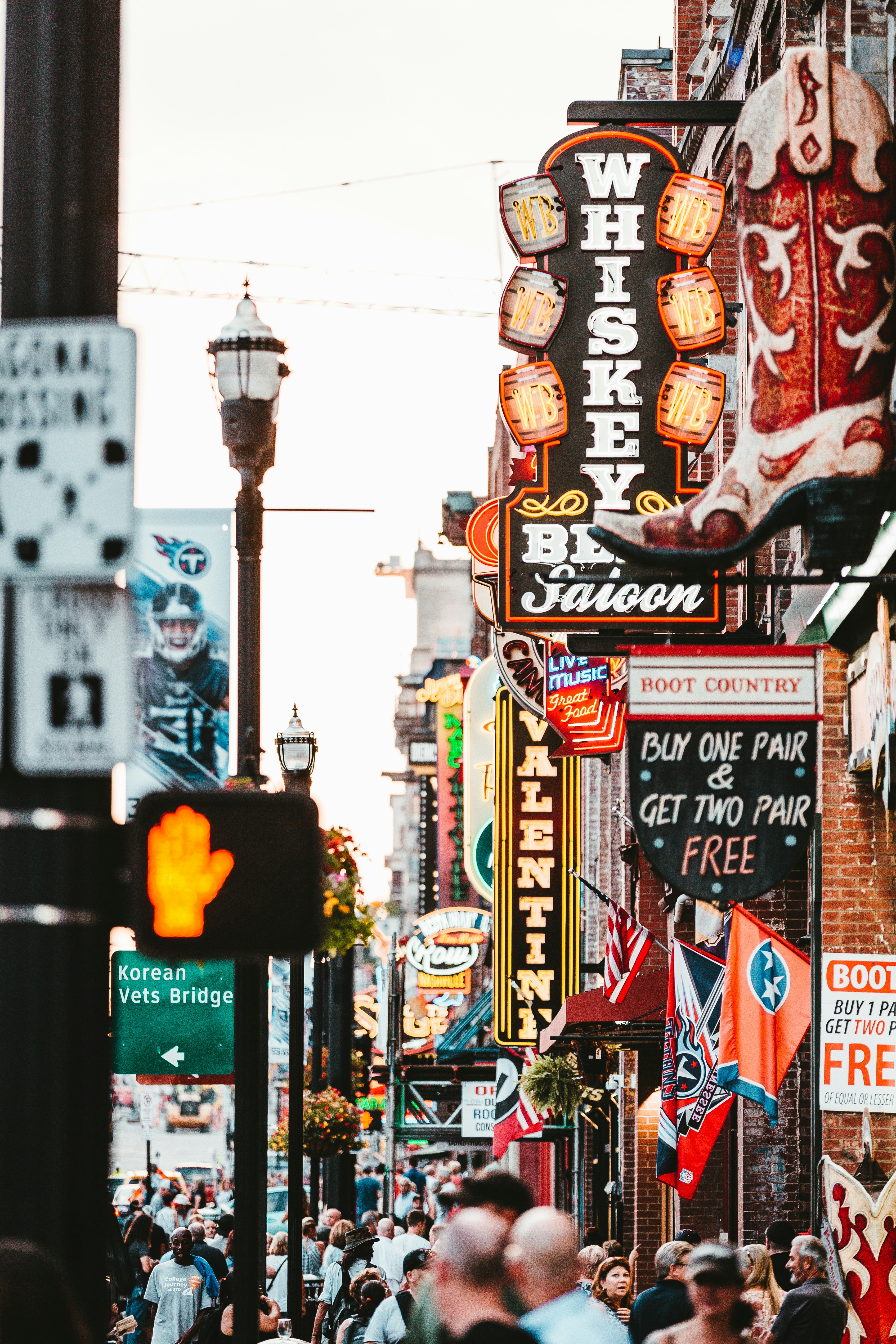 crowded street of downtown nashville featuring whiskey bars and boot shops