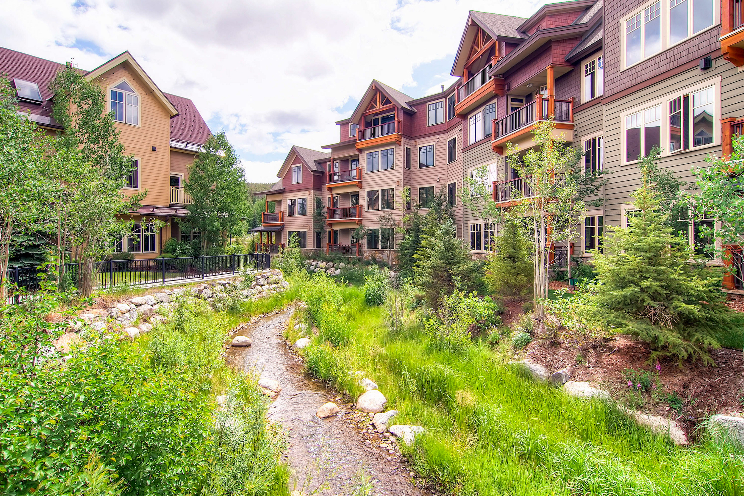 main street station buildings surround a small creek in breckenridge, co