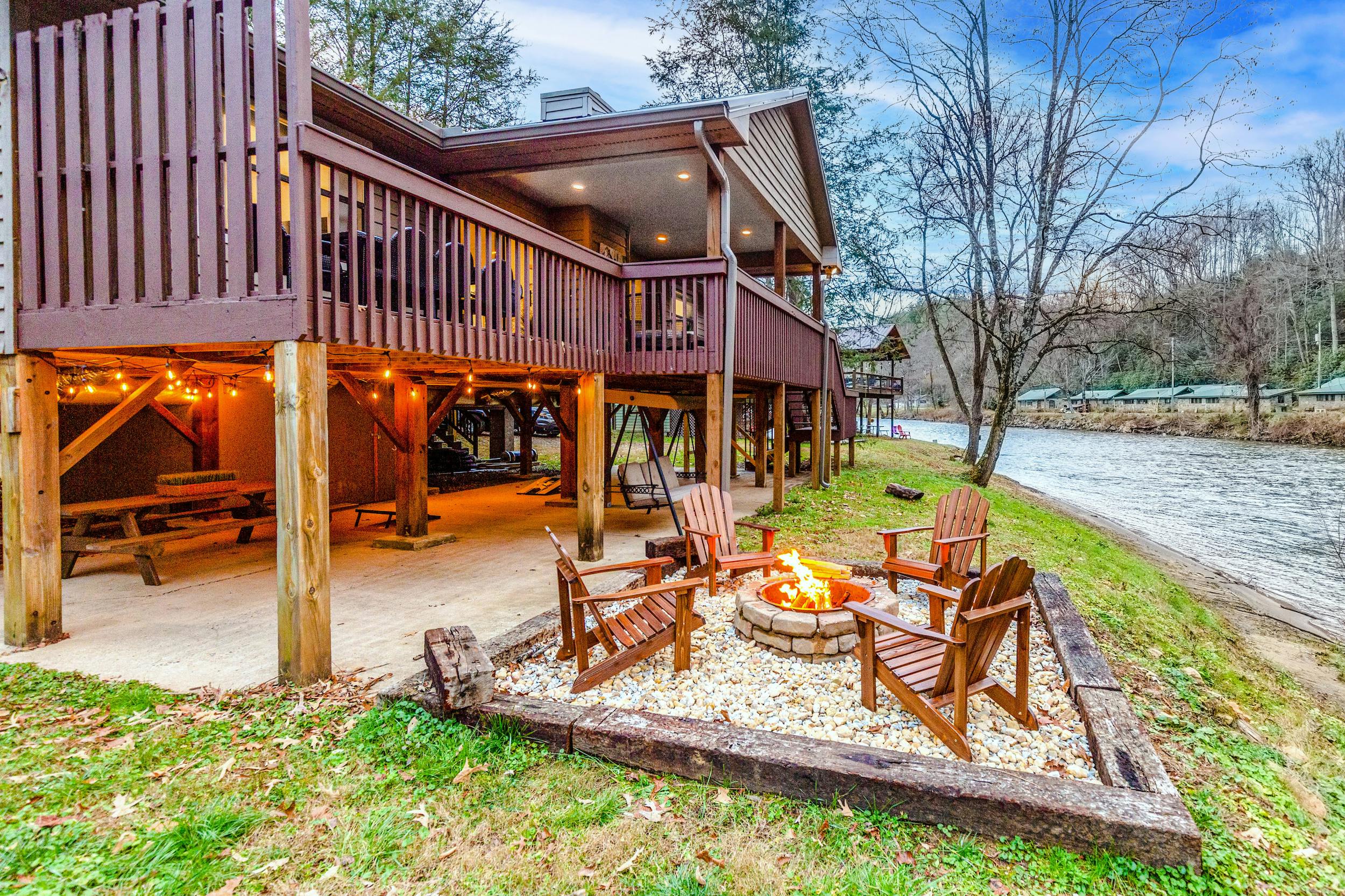 fire in a firepit near a river outside a smoky mountains vacation rental
