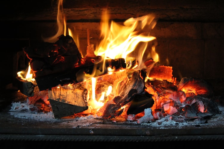 close up of fire in a log fireplace