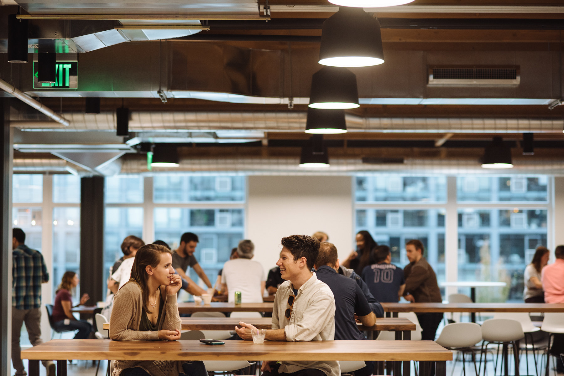 Heartline office open house with groups of people chatting at tables