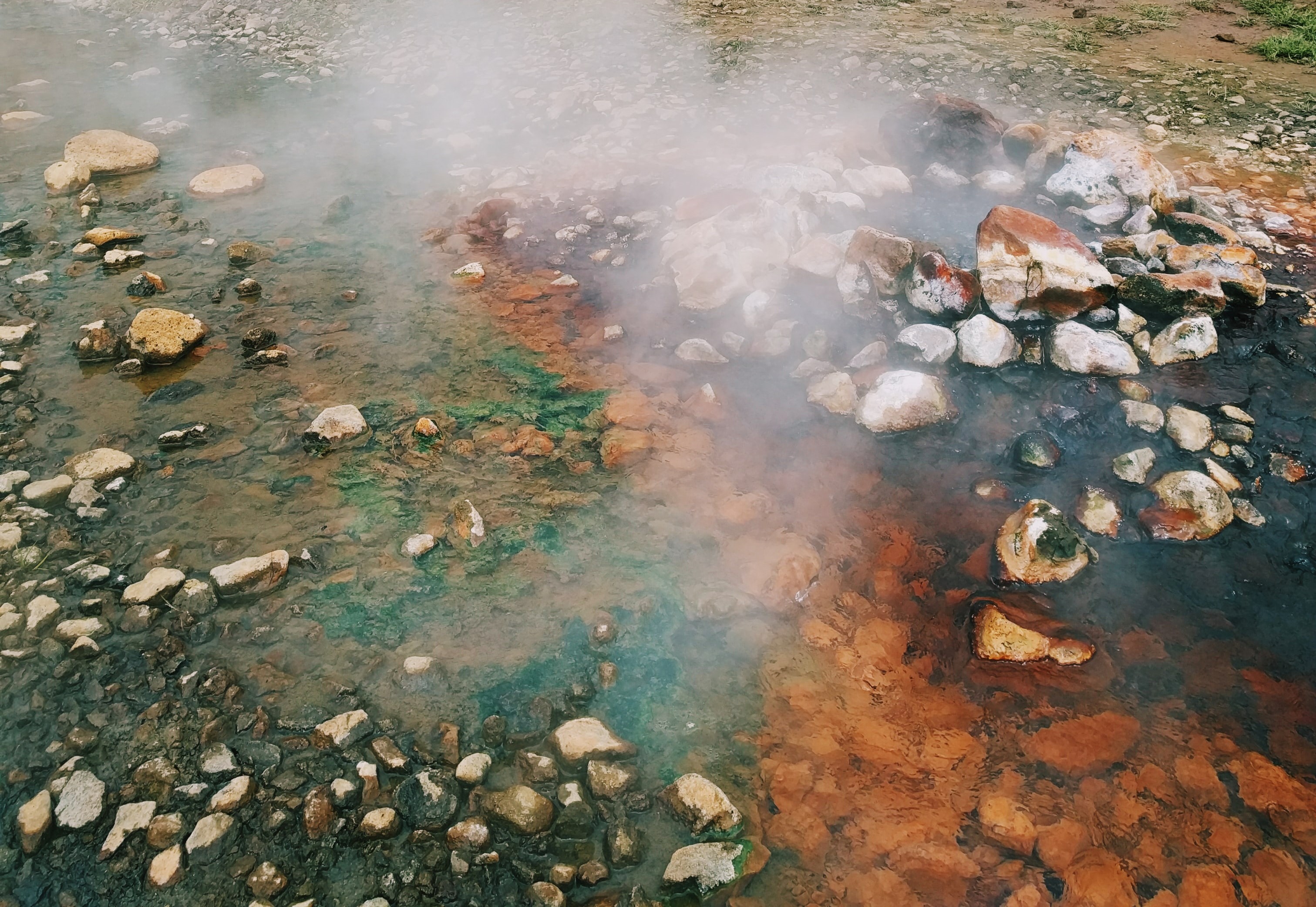 A hot spring alongside a stream and rocky shore in McCall, ID.