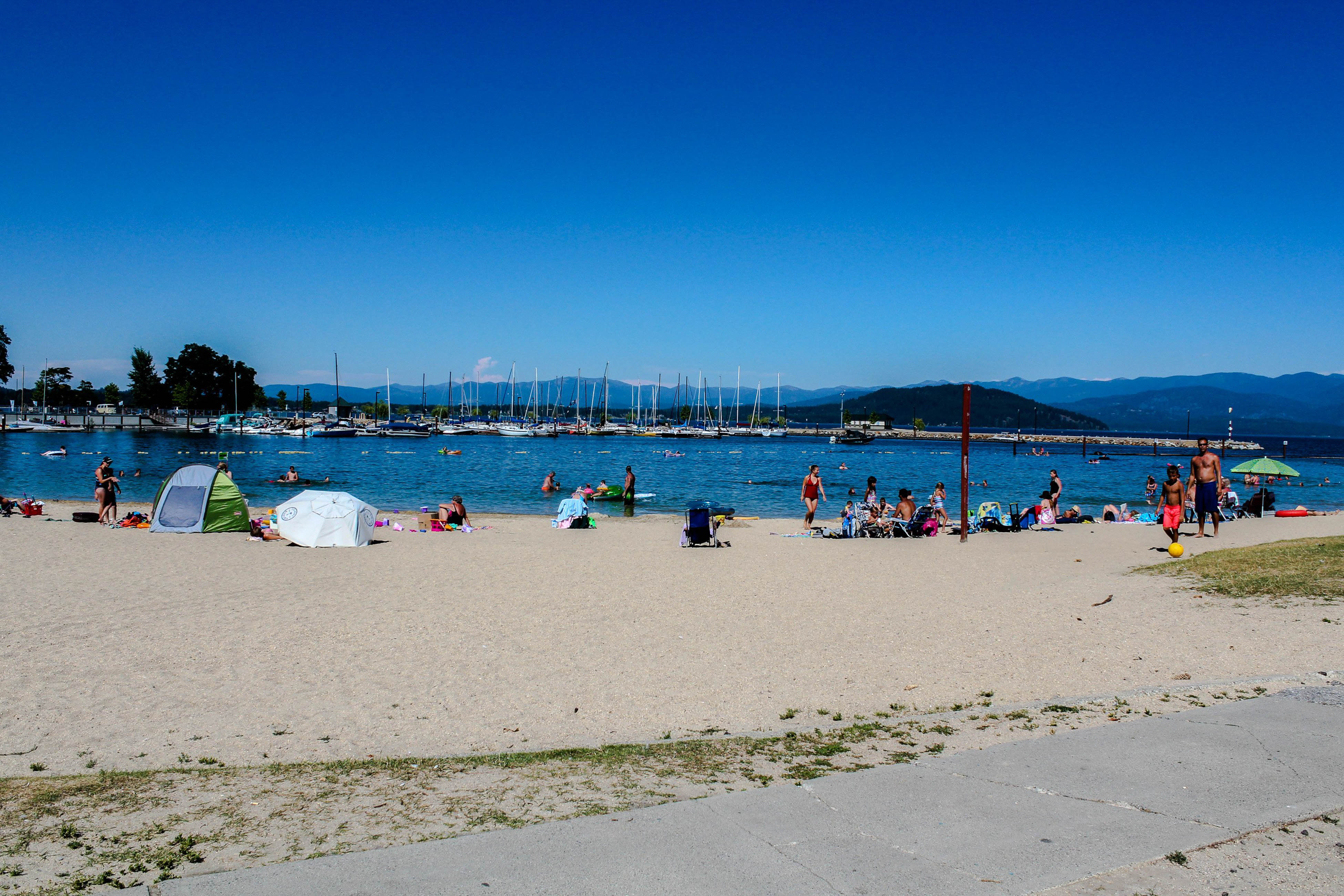 Crowded sandy shore near a boat dock in Idaho.