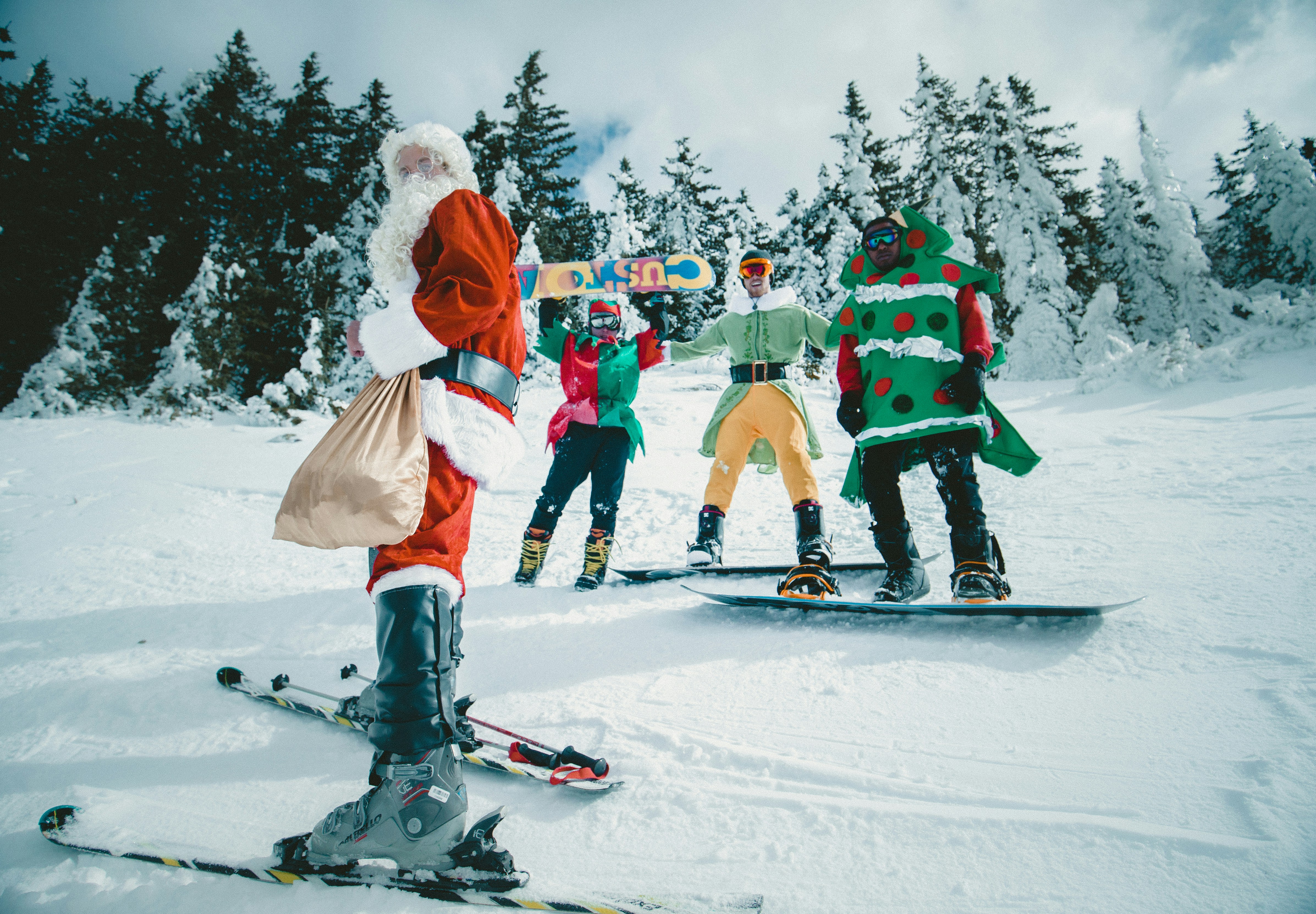 santa and elves snowboarding