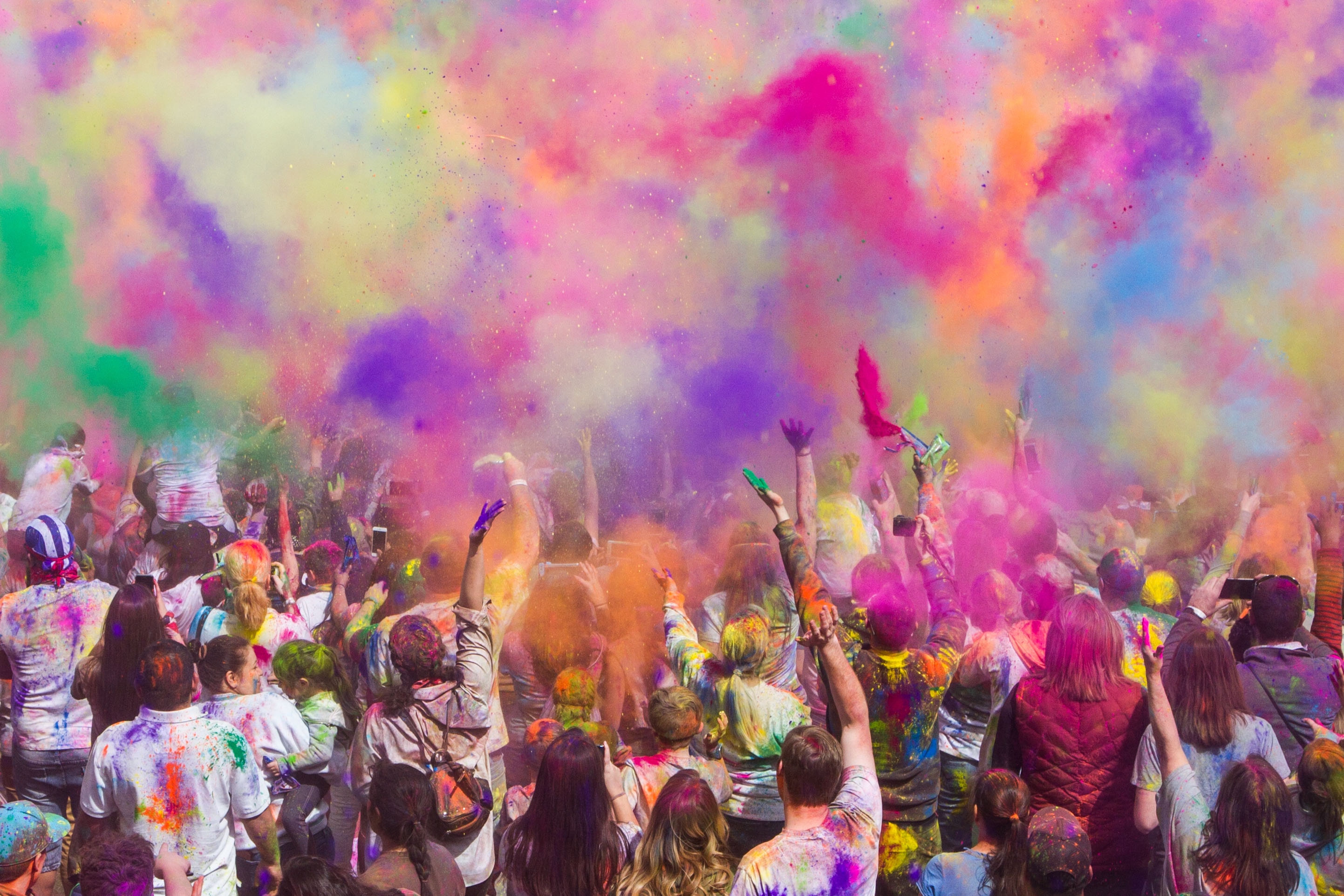 Crowd at a festival with colors everywhere.