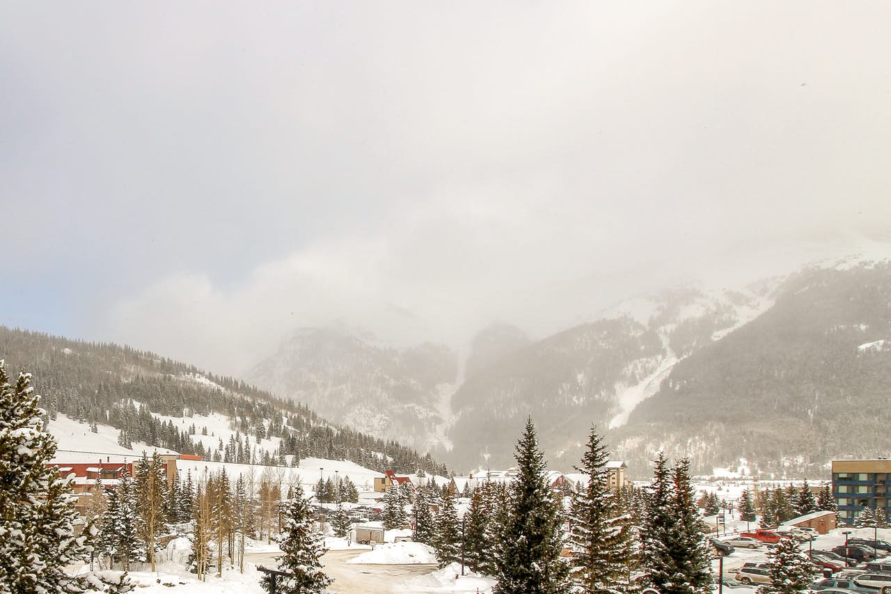 a landscape photo of snow falling over Copper Mountain