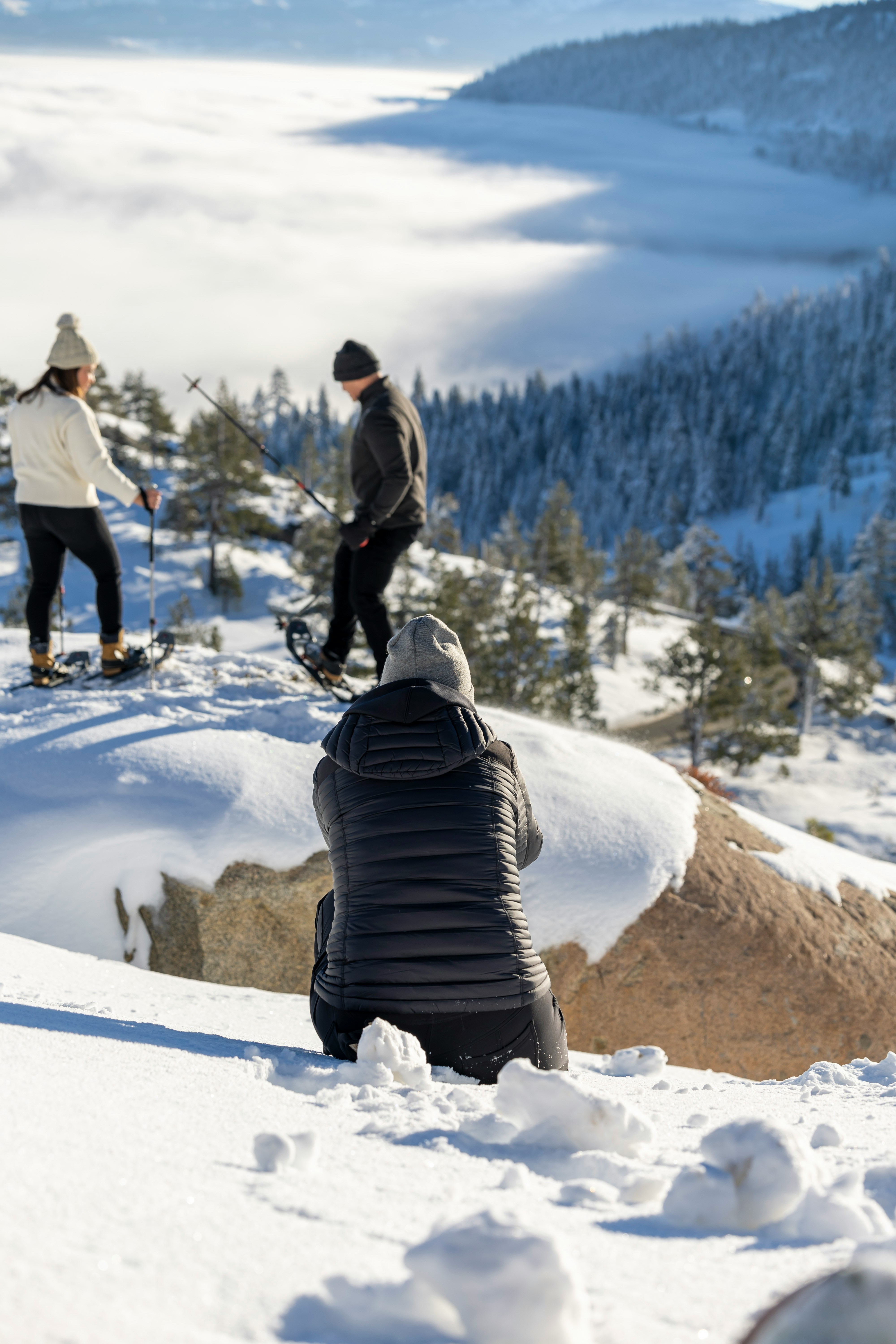 two people snowshoe in truckee while someone take their picture in winter