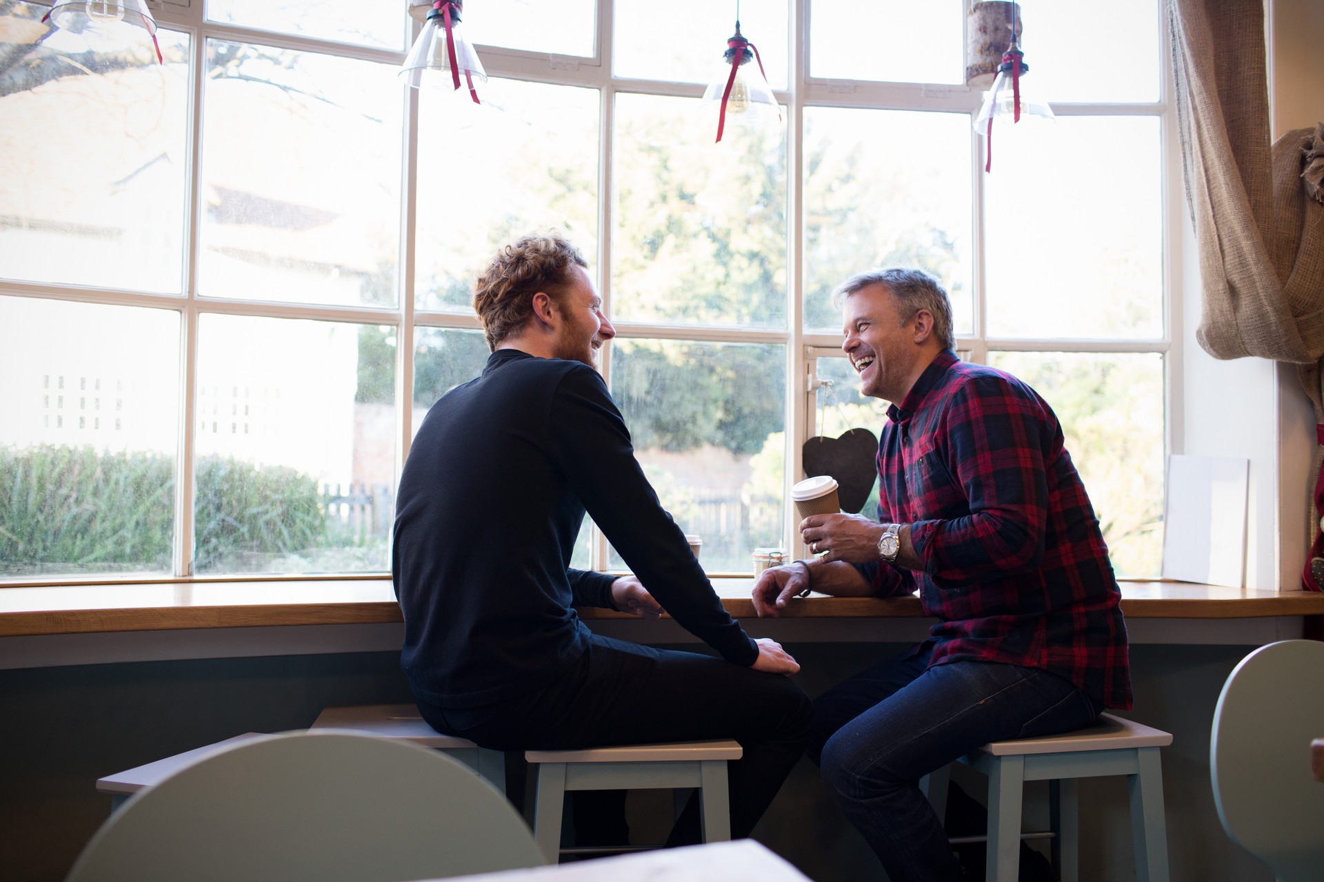 Two people relaxing and enjoying coffee at a coffee shop