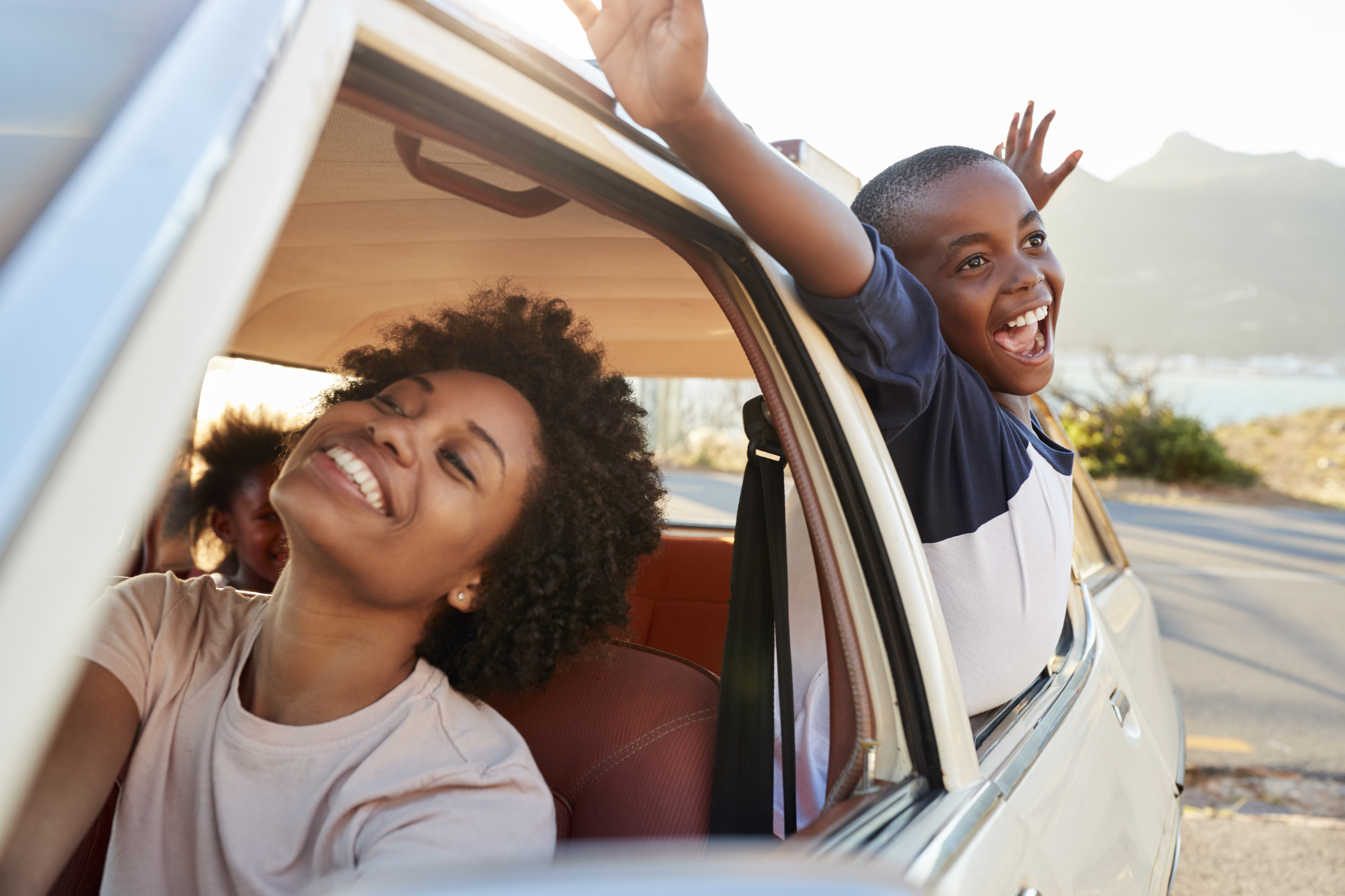 Family enjoying a car ride