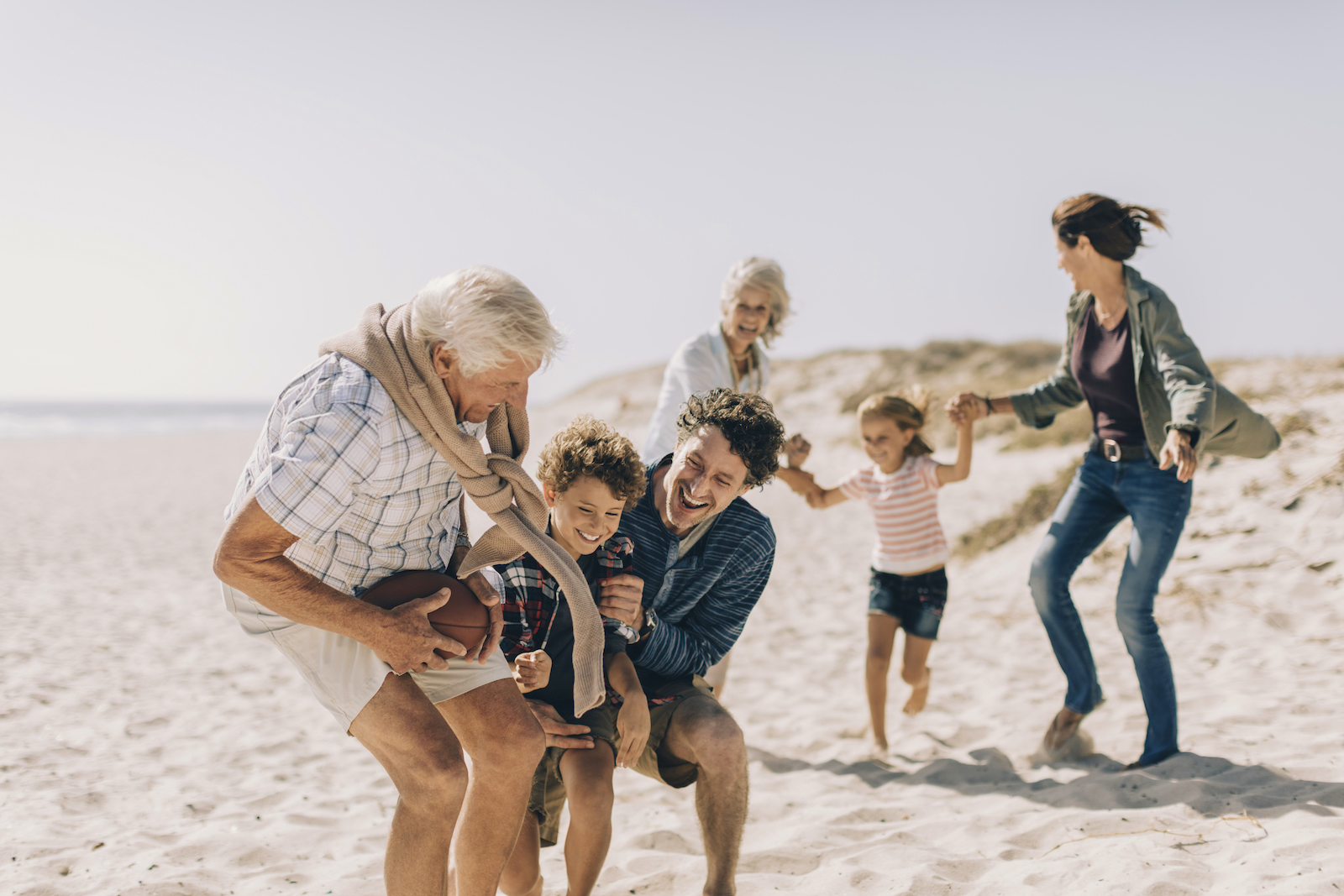 Multi-generational family having fun at the beach