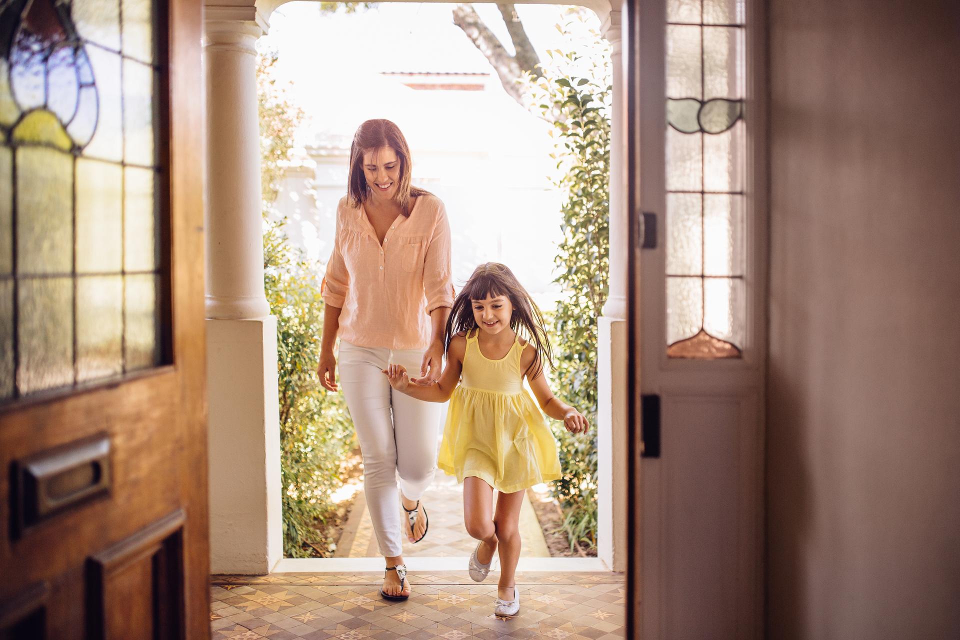 mother and child walk through front door of vacation rental
