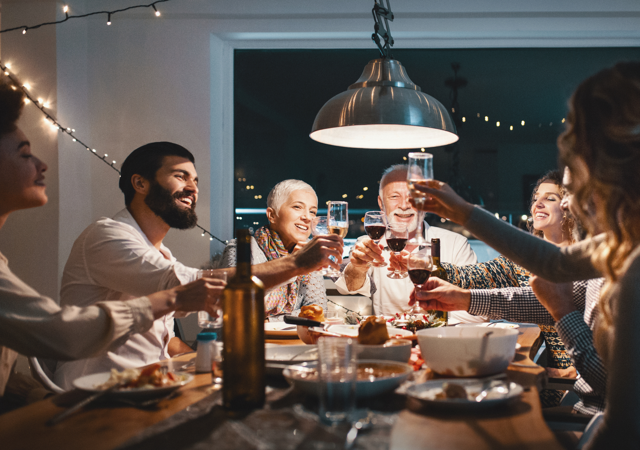 Friends raising their glasses to celebrate their holiday meal