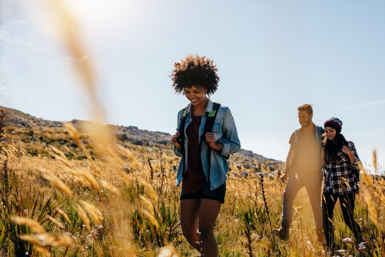 friends hiking in field